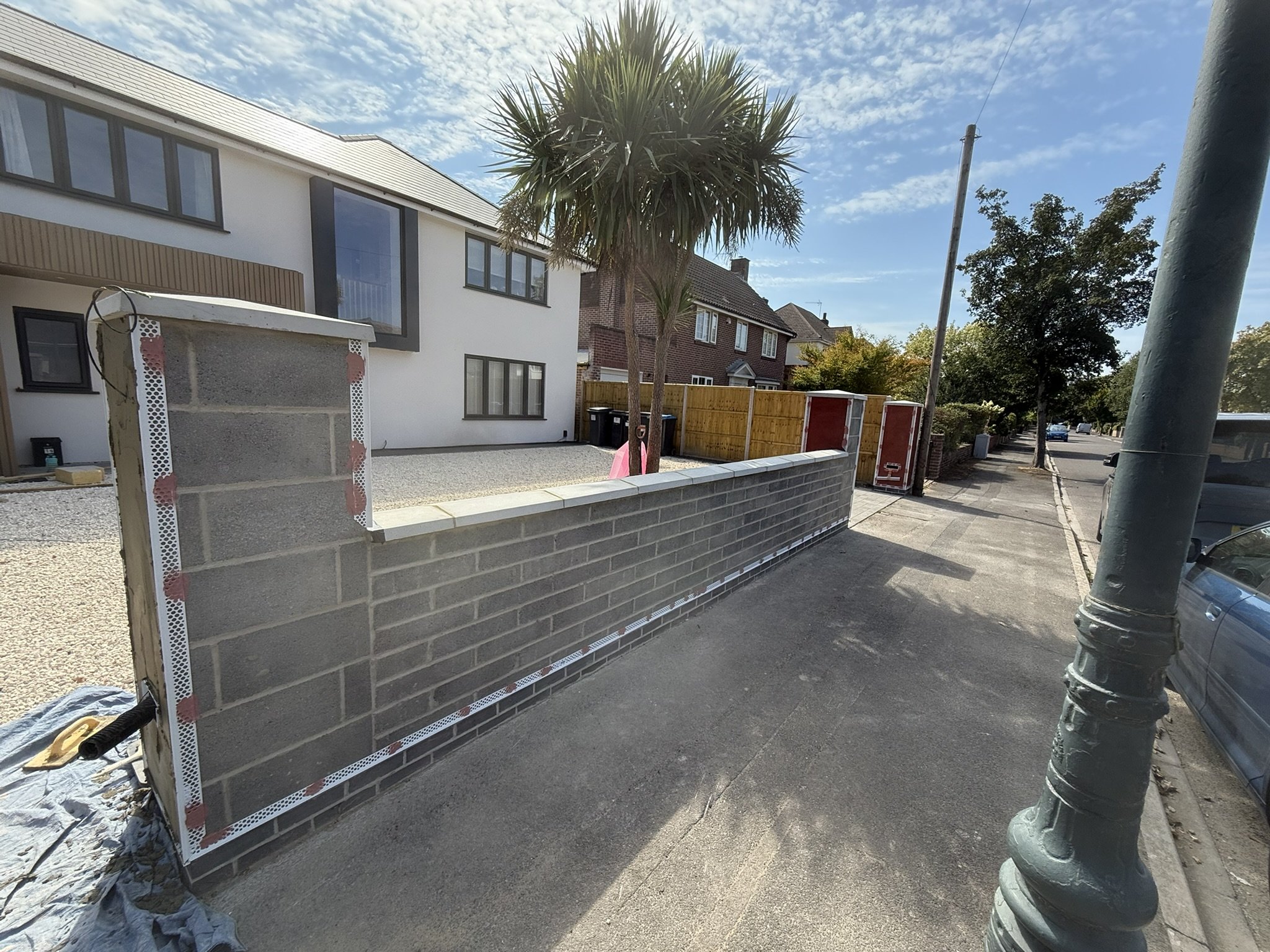 Picture of wall prior to render where rendering beads have been fitted with Pinkgrip before the wall is rendered.