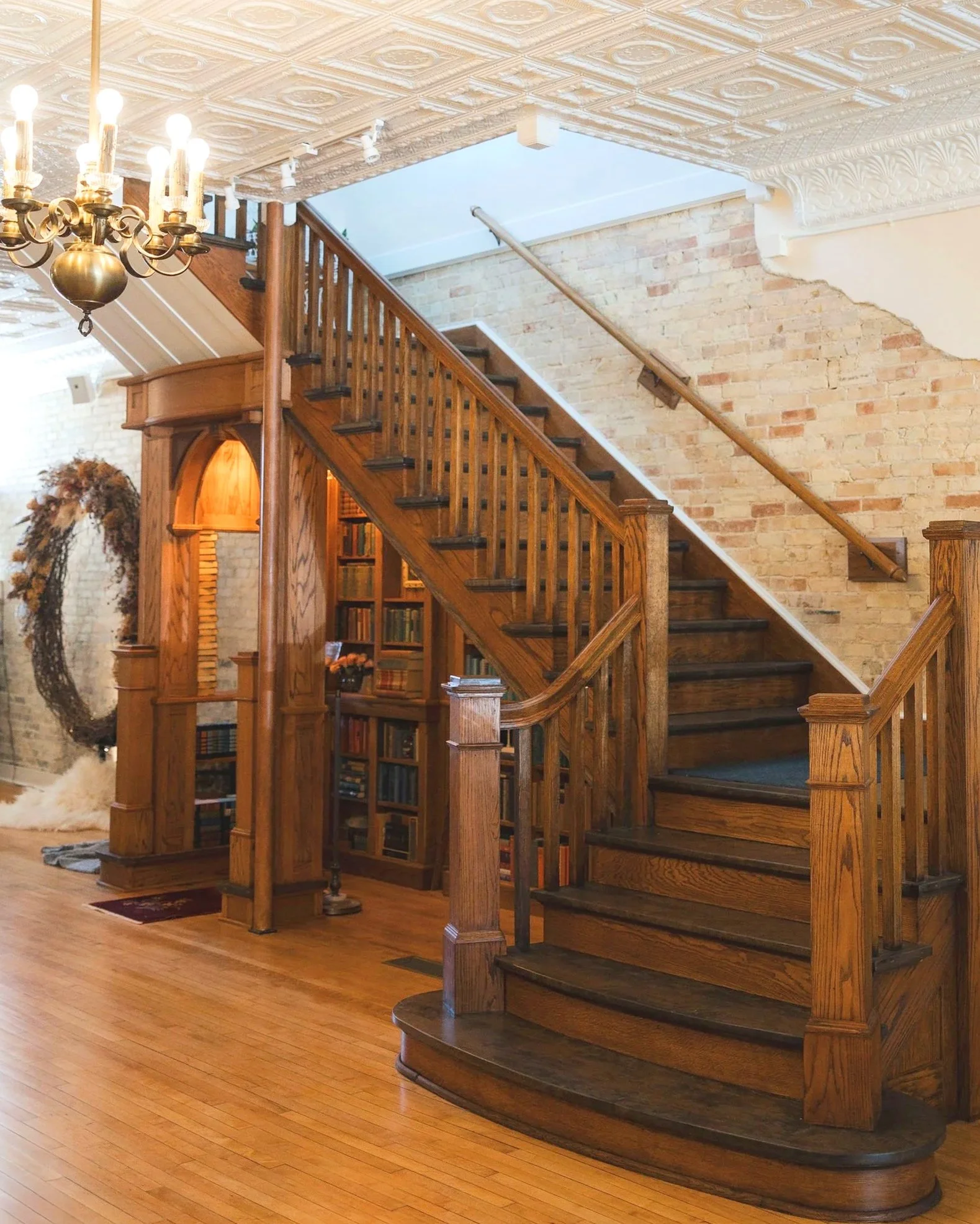 Focal point of the 1st floor, our massive oak and birds eye maple staircase with the lovingly custom made Atria Alcove, created within it. 