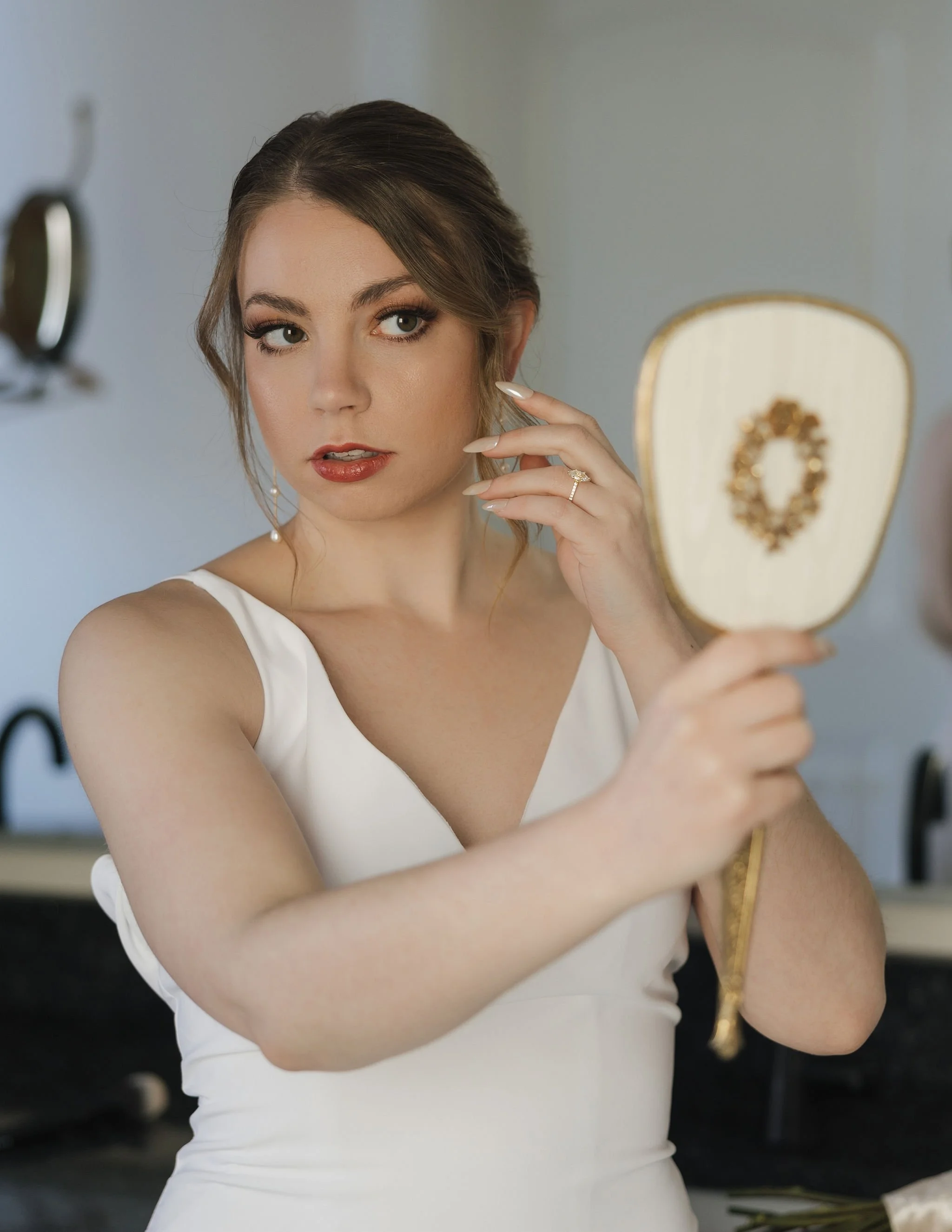 Checking details with one of our vintage hand mirrors