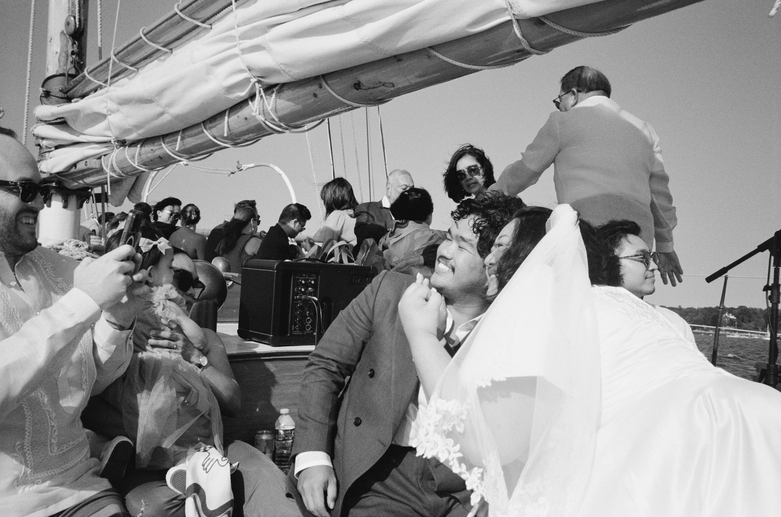 bride and groom smiling  on portland schooner after wedding