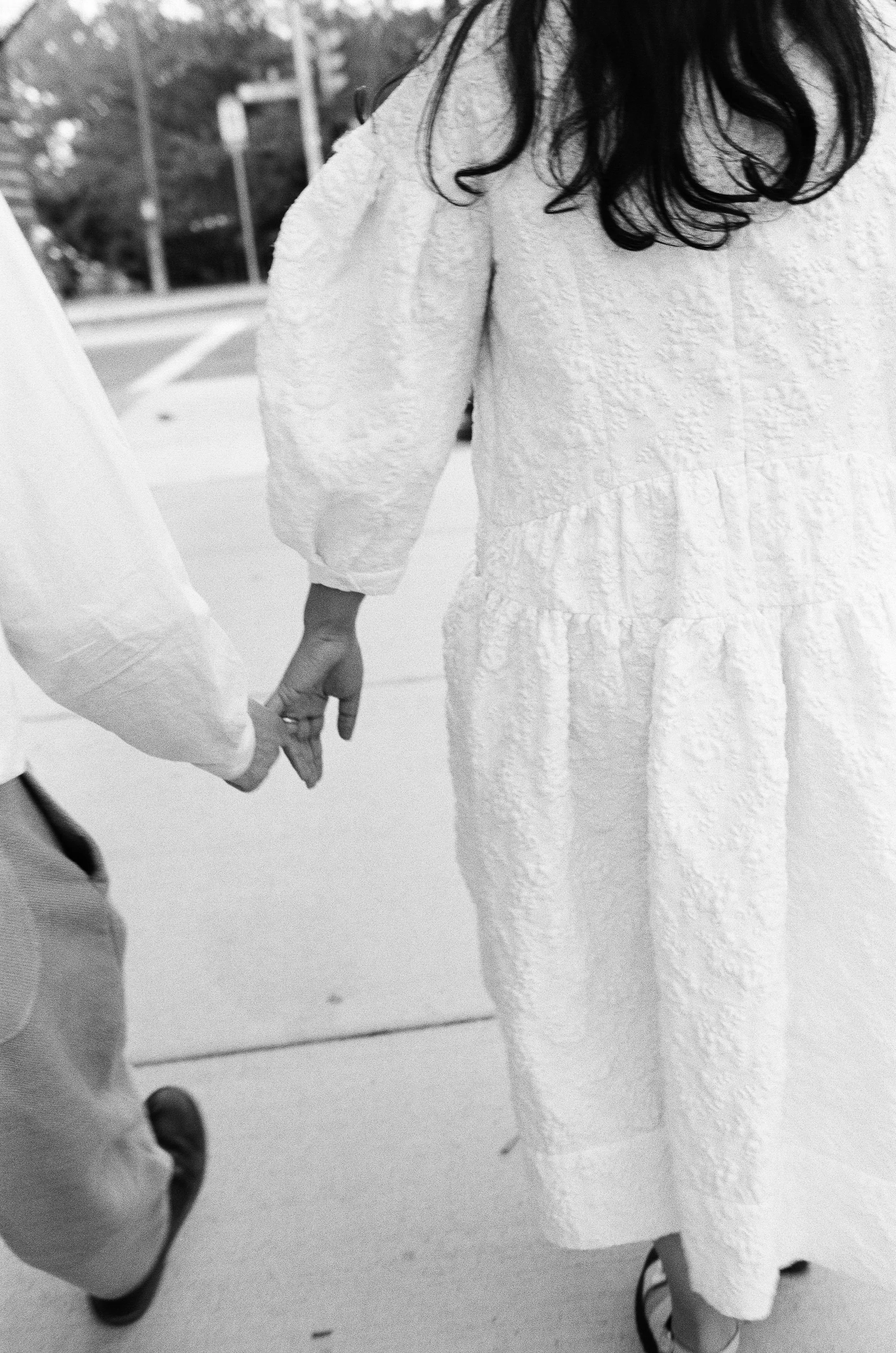 candid of a couple holding hands 