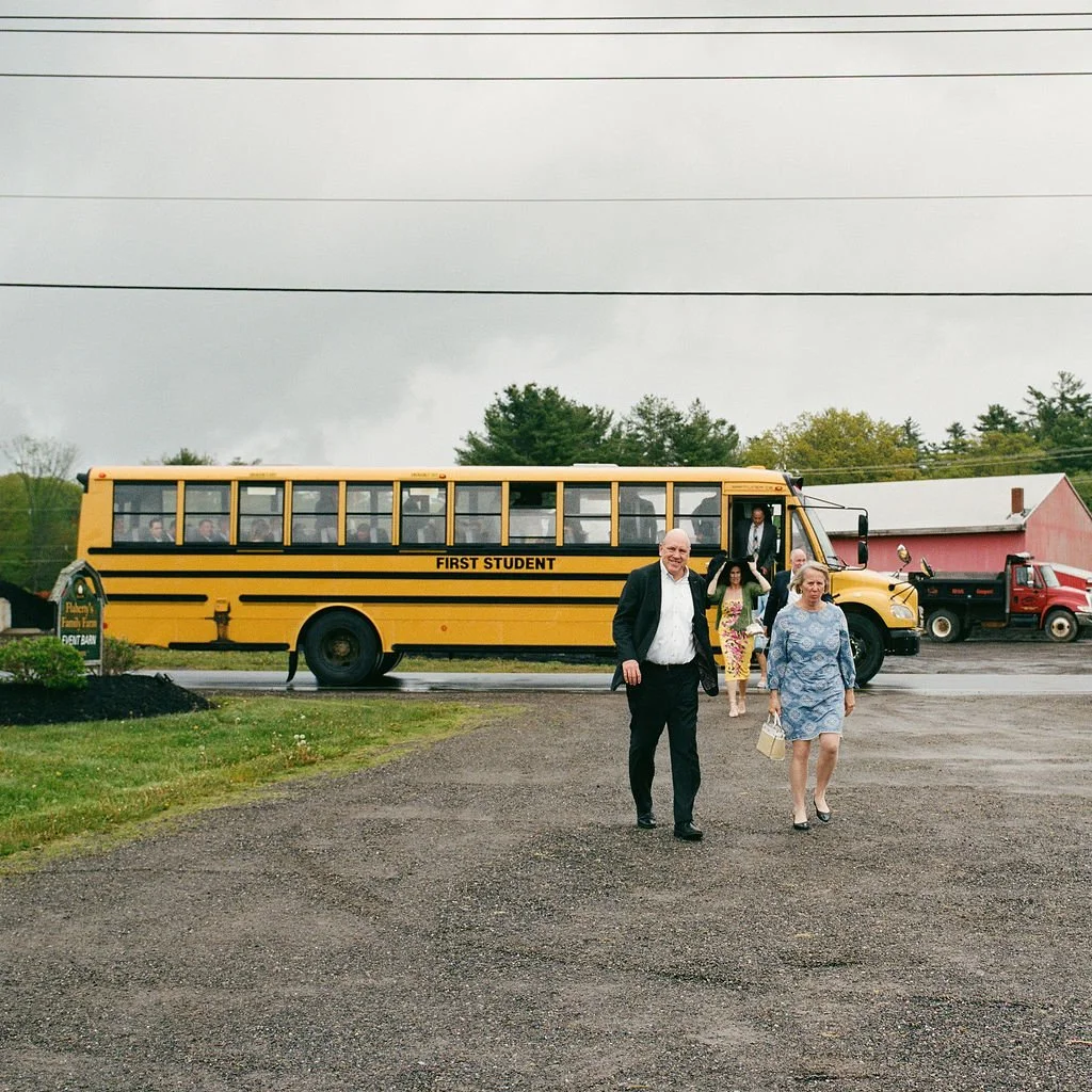the wedding guests leave a school bus to enter a wedding in southern maine