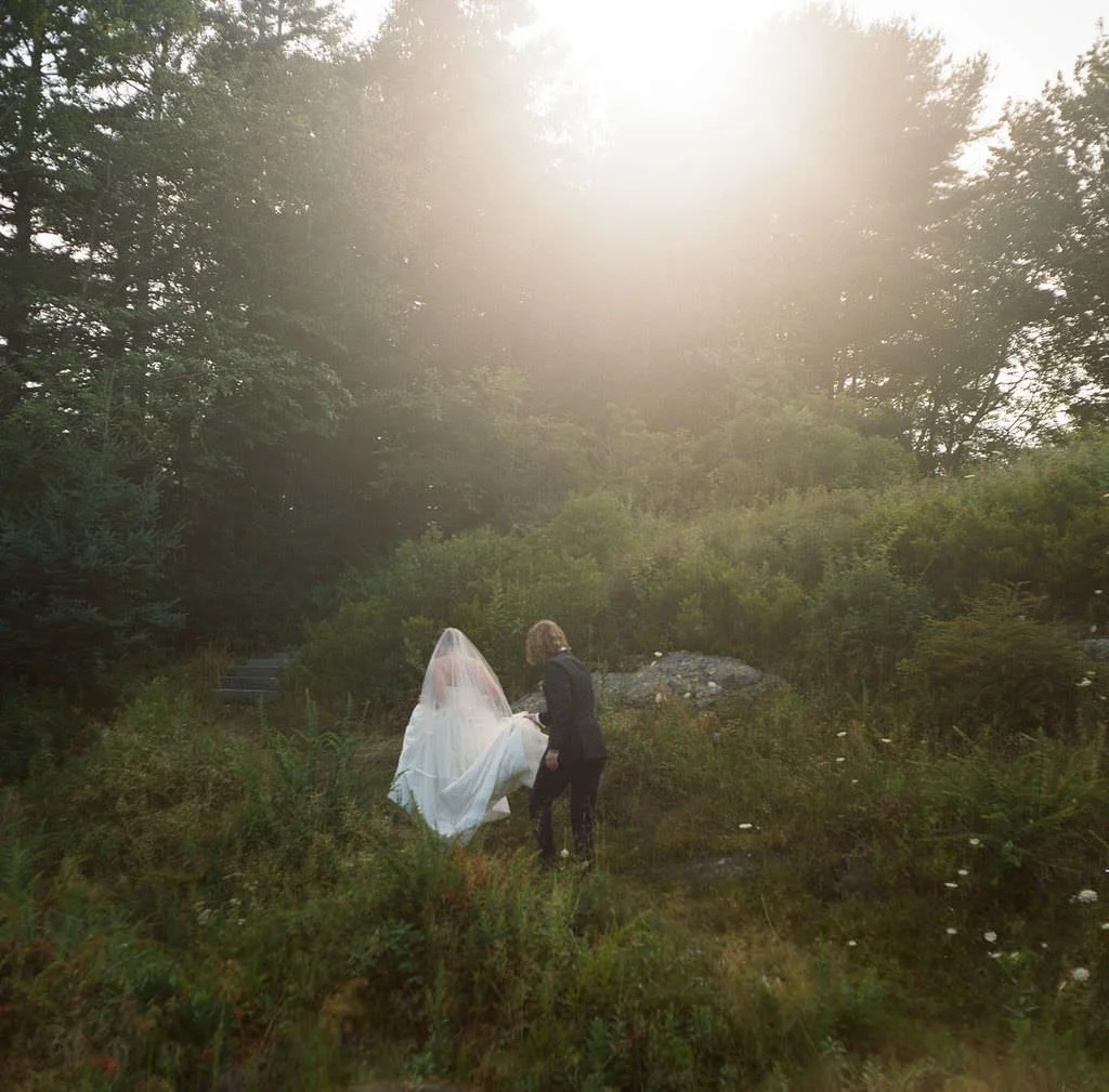 Candid of a couple walking up a forested path after their portrait session
