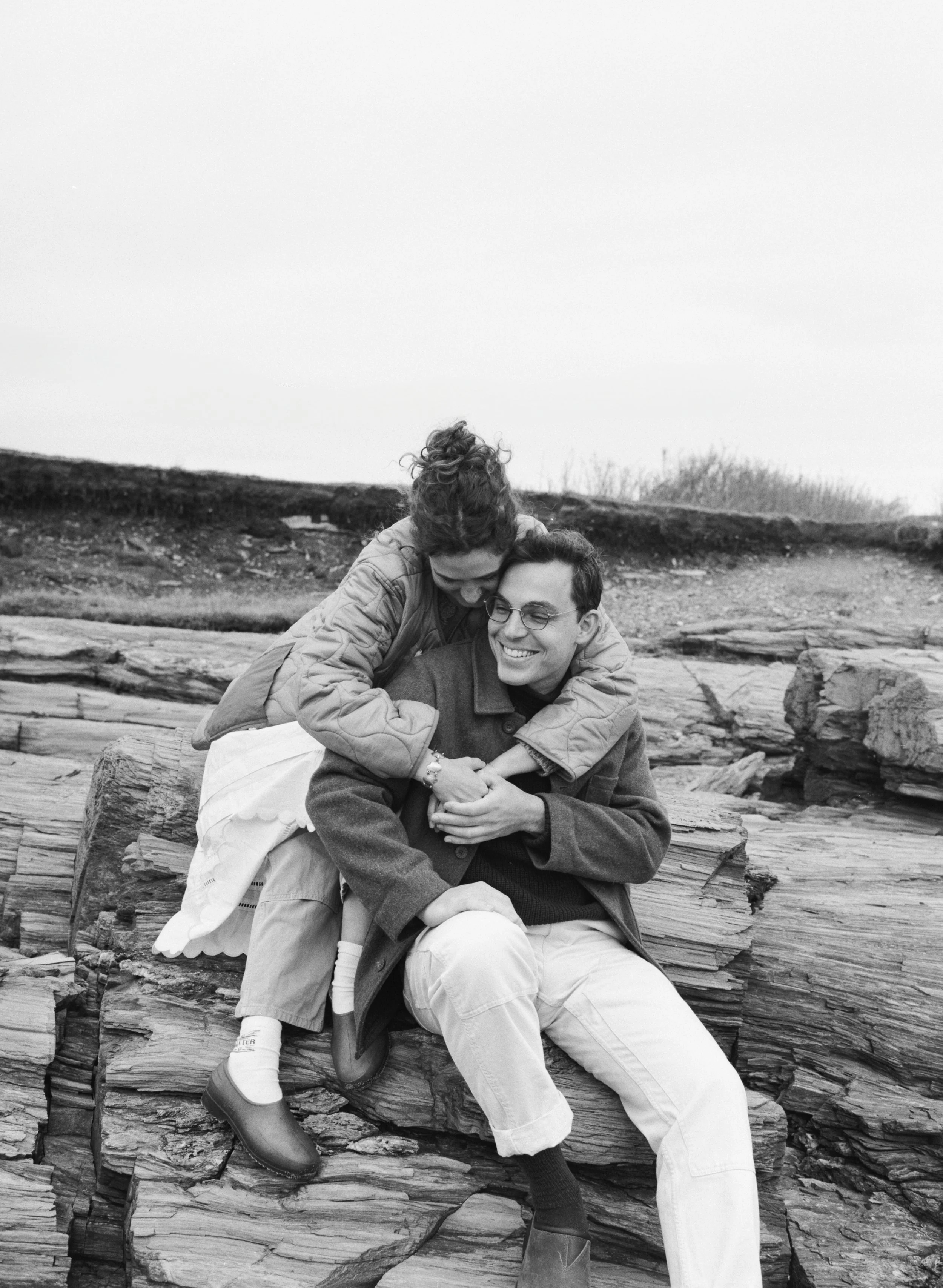 a couple embraces candidly during engagement session in portland maine