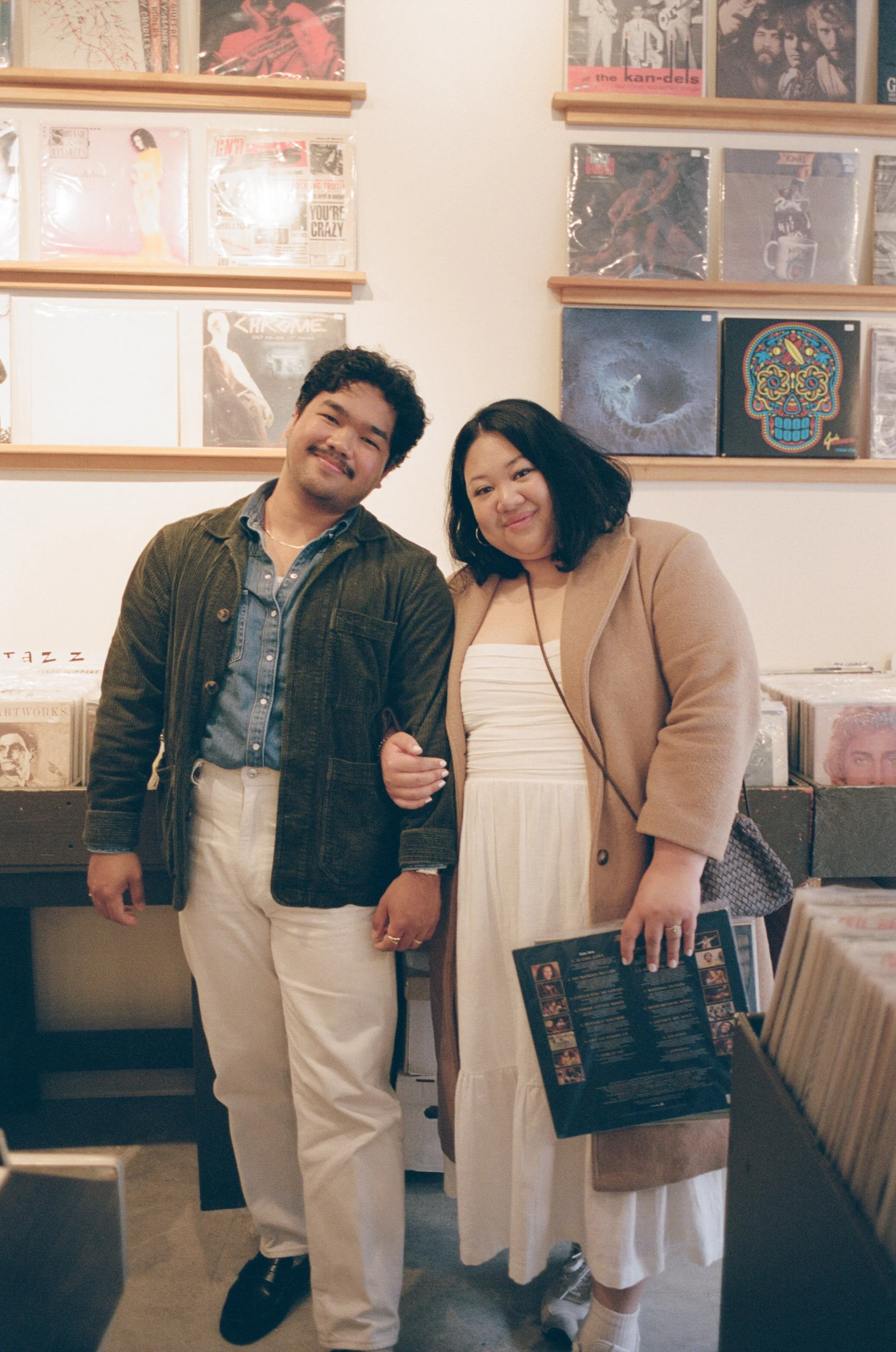A couple is record shopping in portland maine during their engagement session