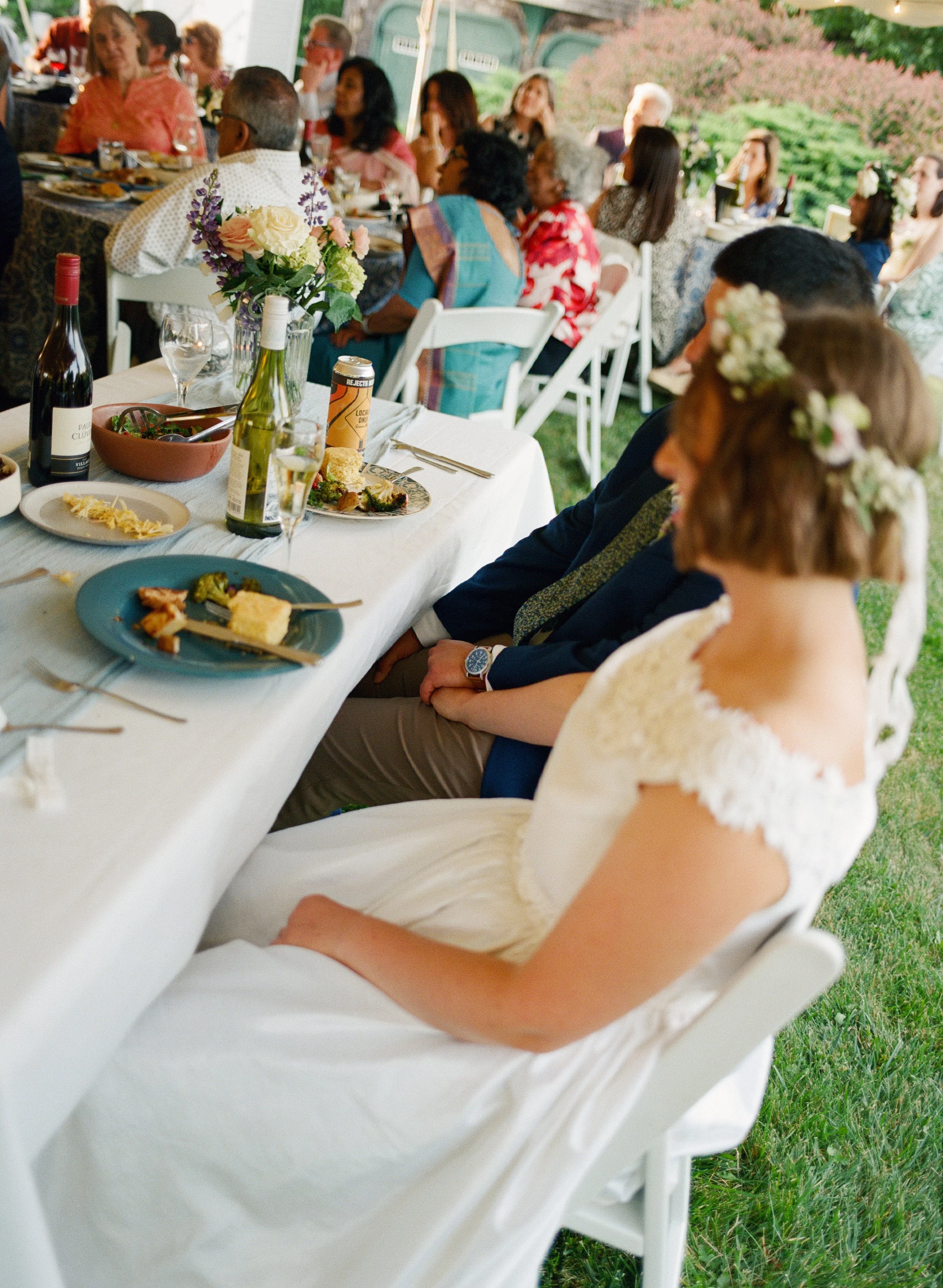 couple golding hands during dinner at backyard wedding