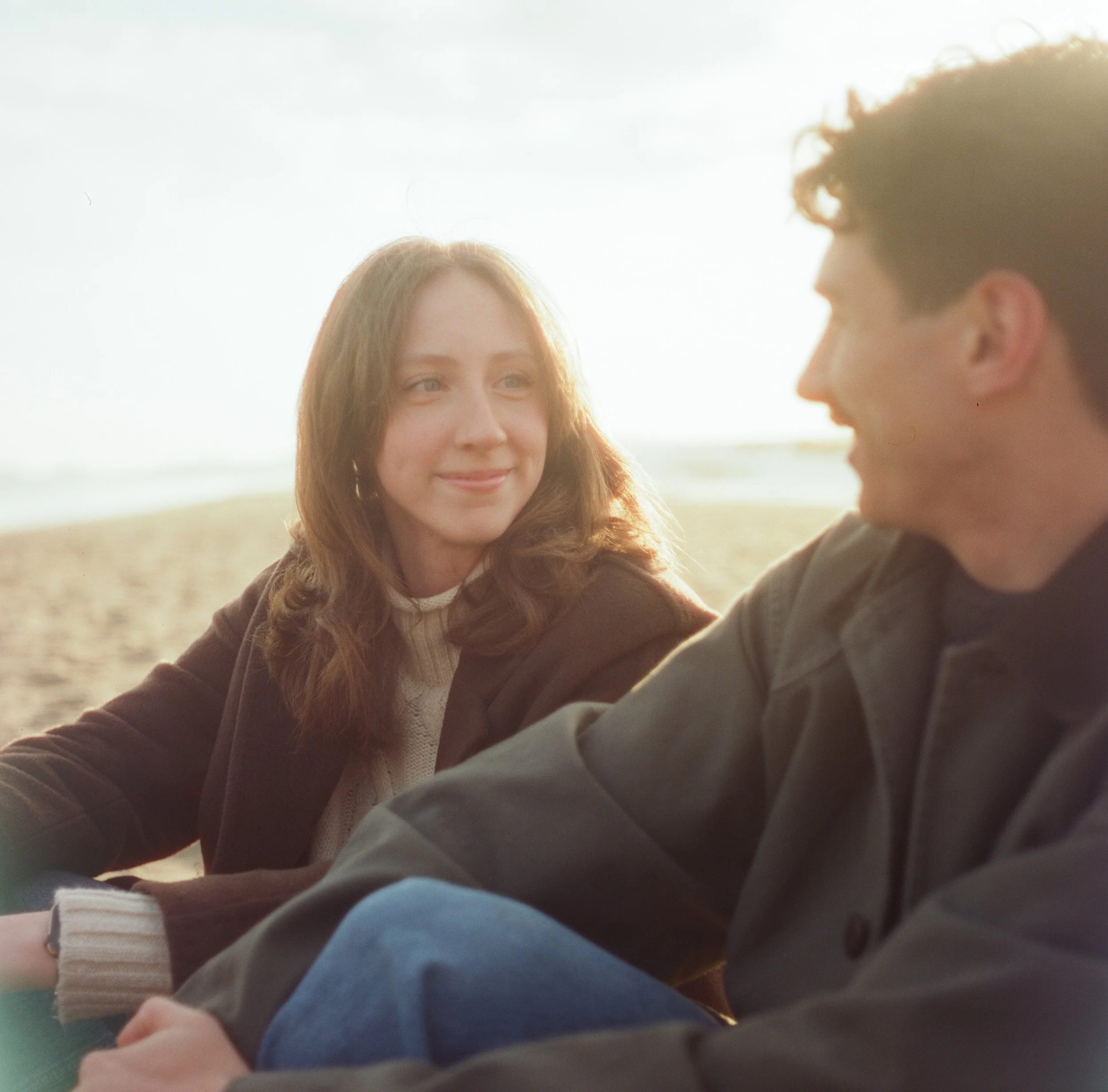 A couple during their sunset engagement session at reid state park beach