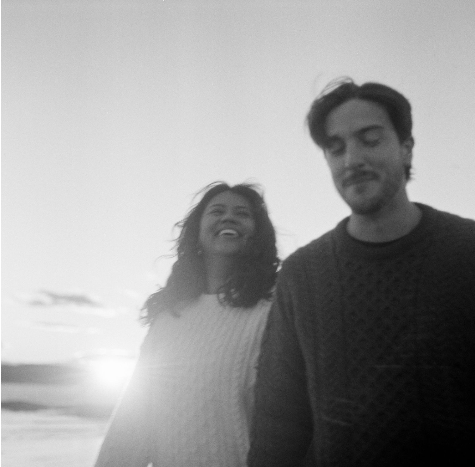 candid of couple walking on beach on film