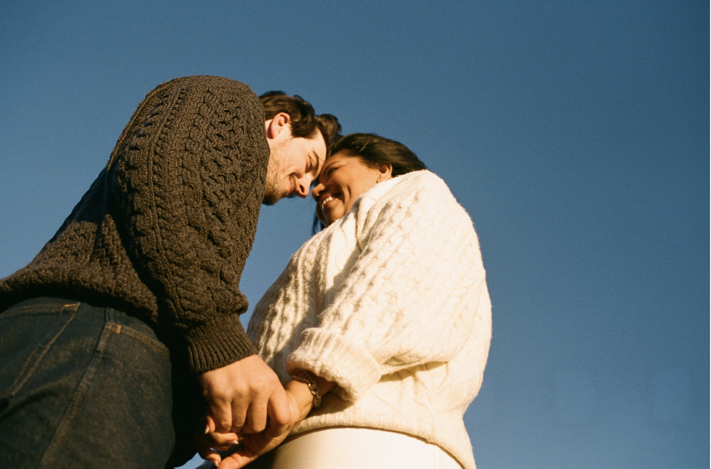 couple holding hands on film