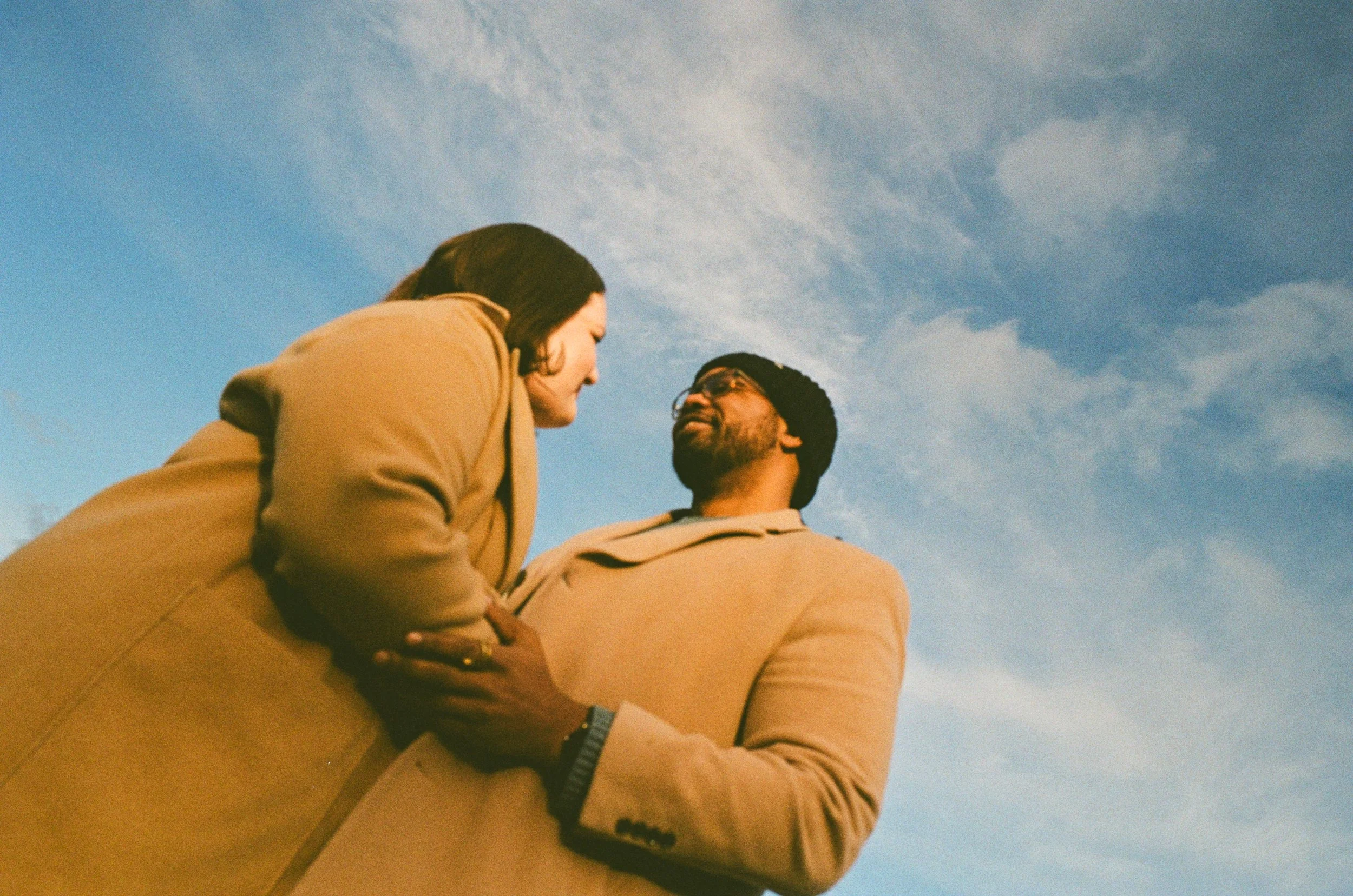 A couple embracing at a park in portland during engagement session