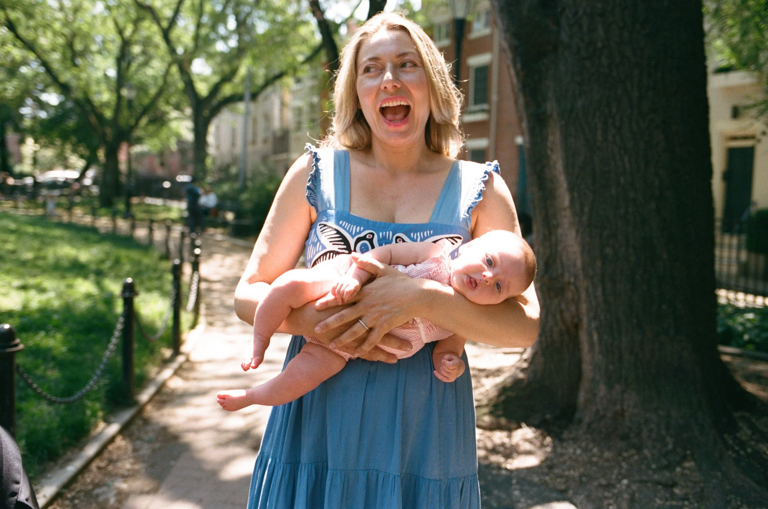 NYC family film photographer joyful, laid back candid photography of a mother with her baby in Carrol Gardens Brooklyn