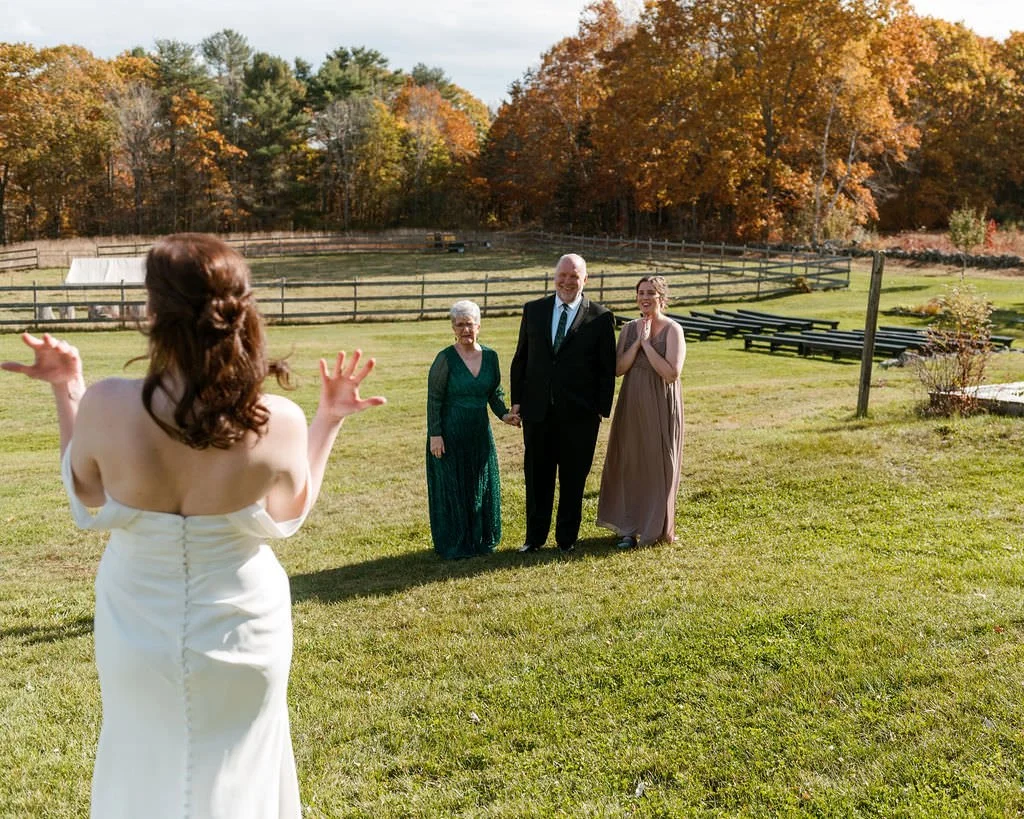 A bride does a first look with her family outside at a farm in Maine on film