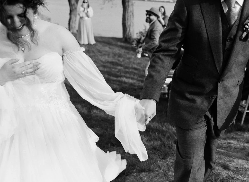 a bride and groom share a sweet intimate moment as they exit their wedding ceremony in main