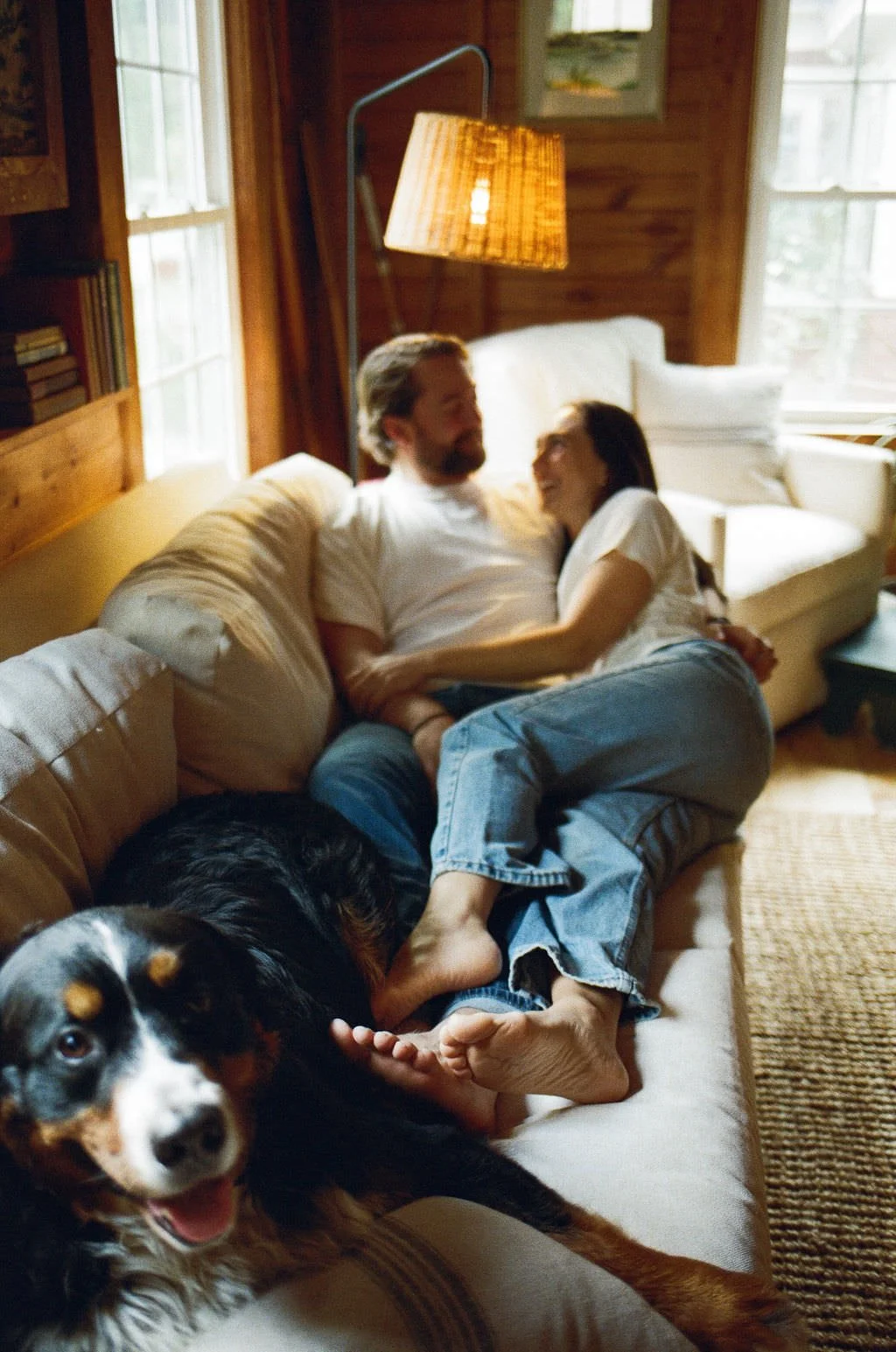 engagement session of a couple at home with their dog