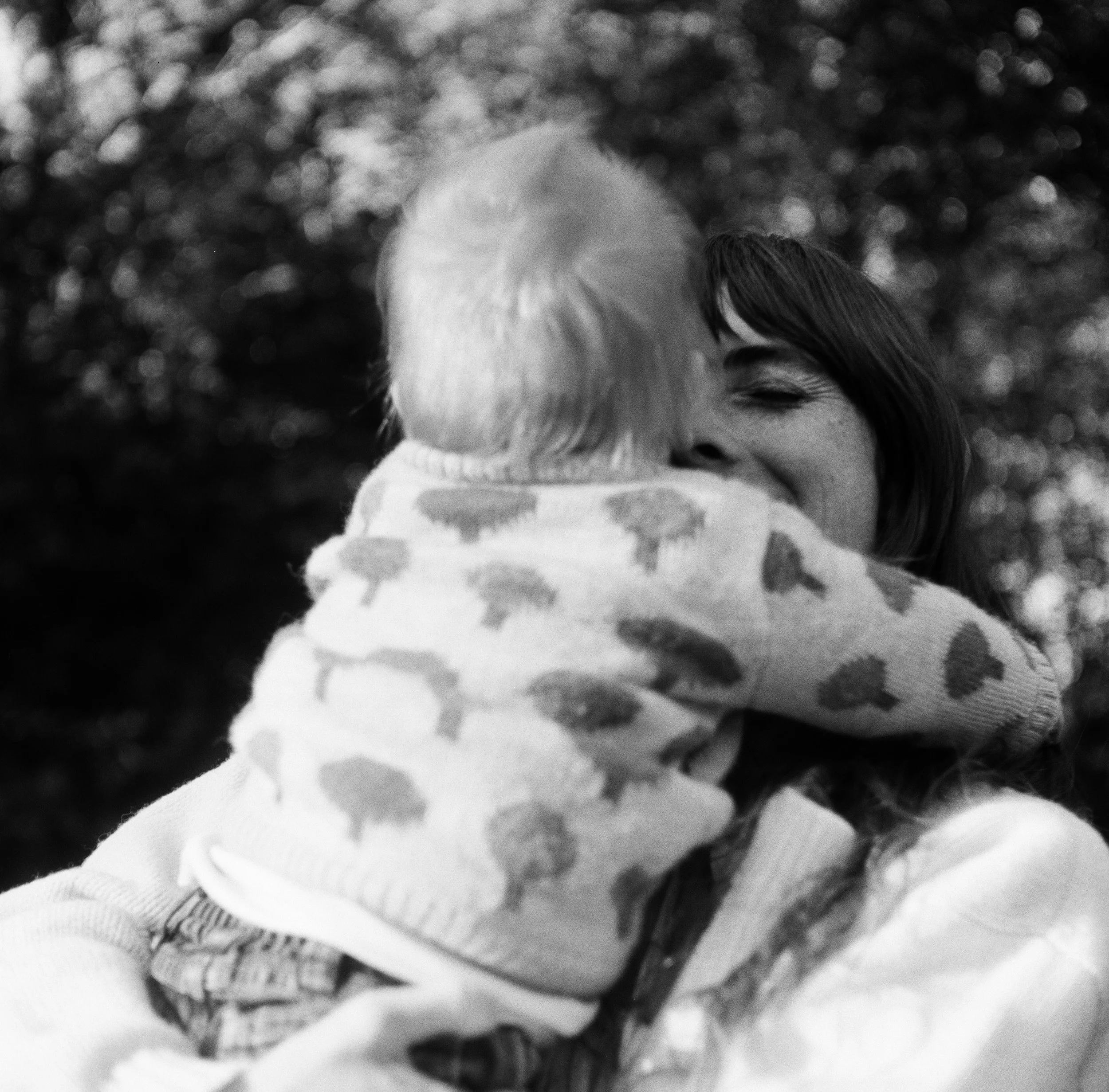 A mother holds her son on film near Camden Maine during an extended family photography session