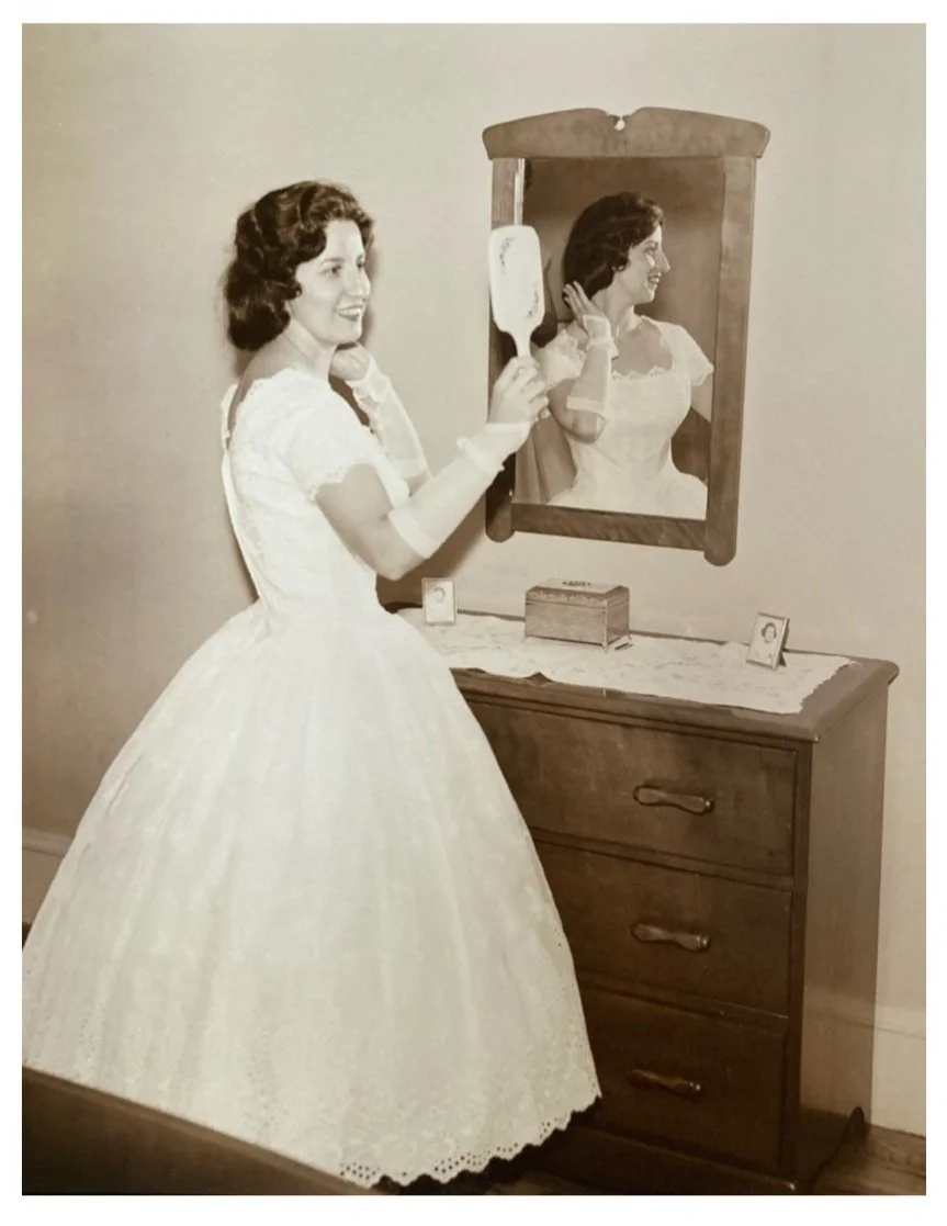 nostalgic wedding photograph of a bride looking in the mirror from the 1950s in New England