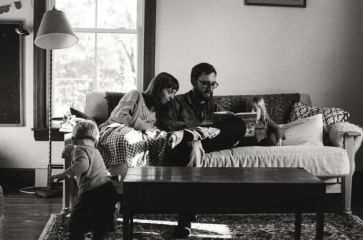 documentary family session at home in maine reading books together on the couch on film
