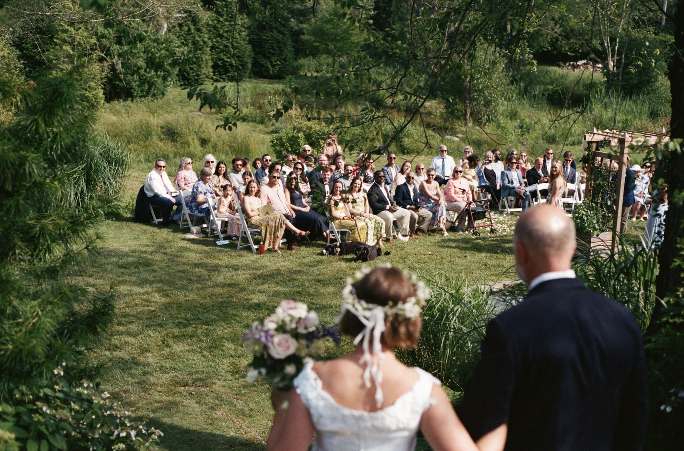 bride and dad walking towards ceremony