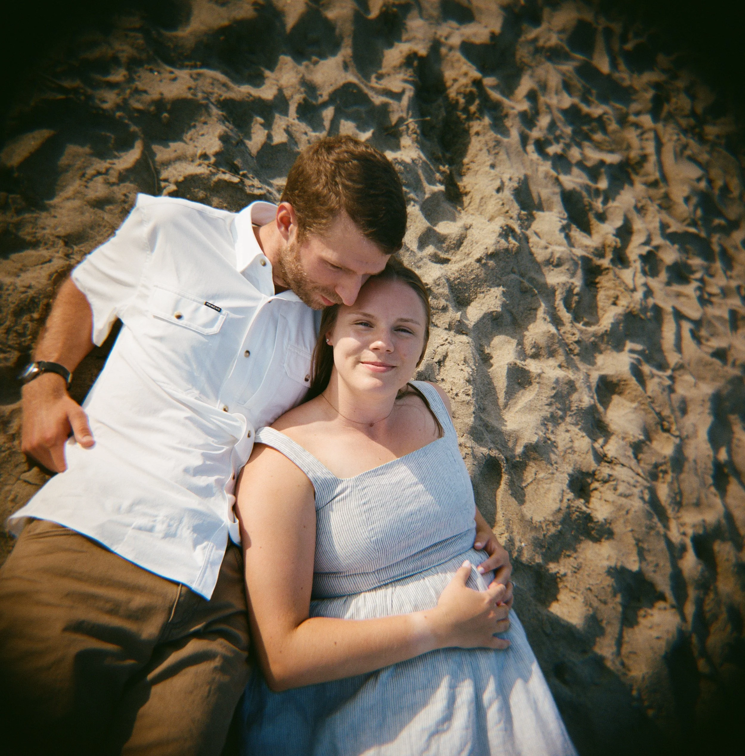 documentary artful portrait of a couple on a beach in maine