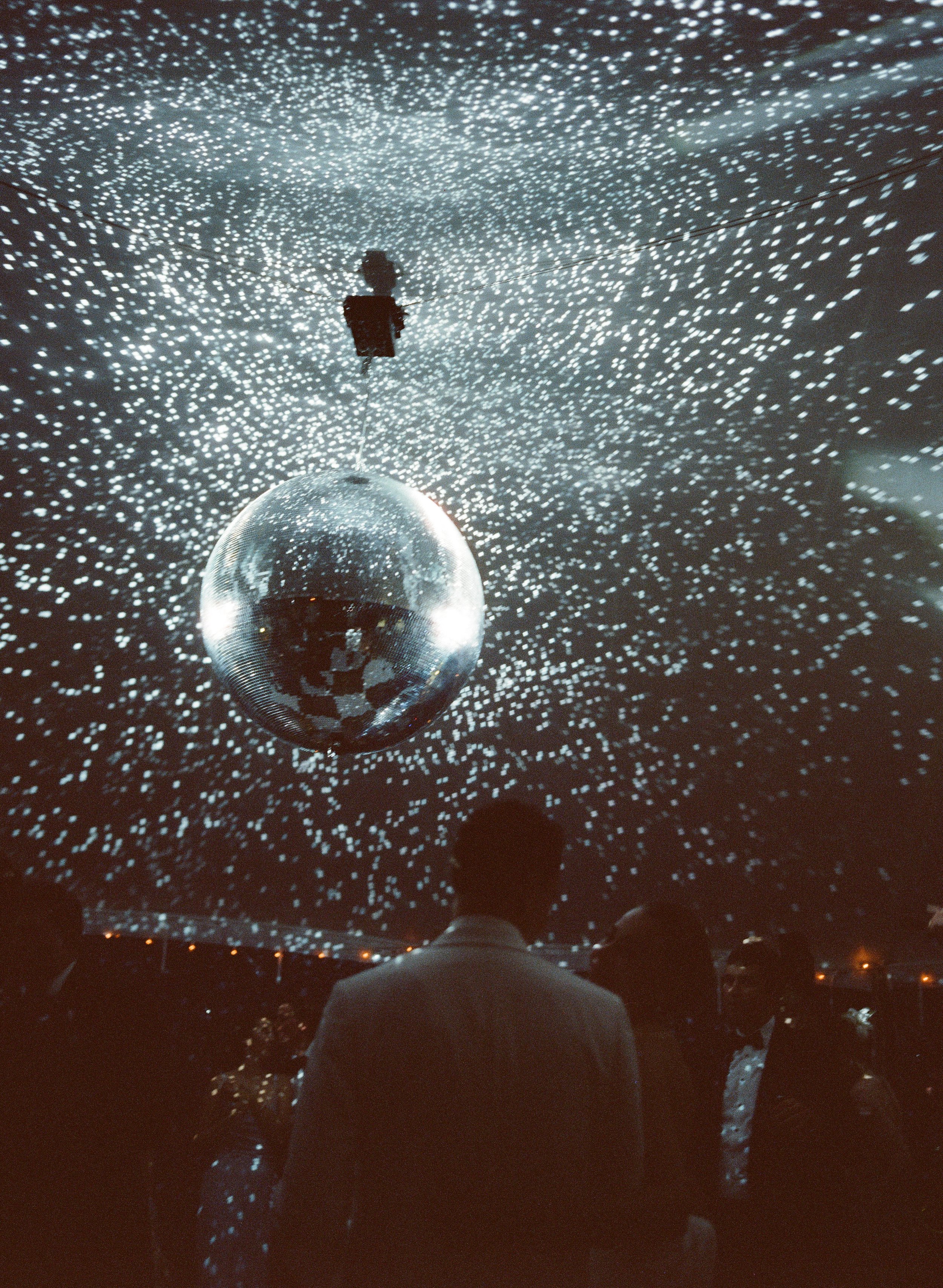 disco ball on tent at maine wedding on film