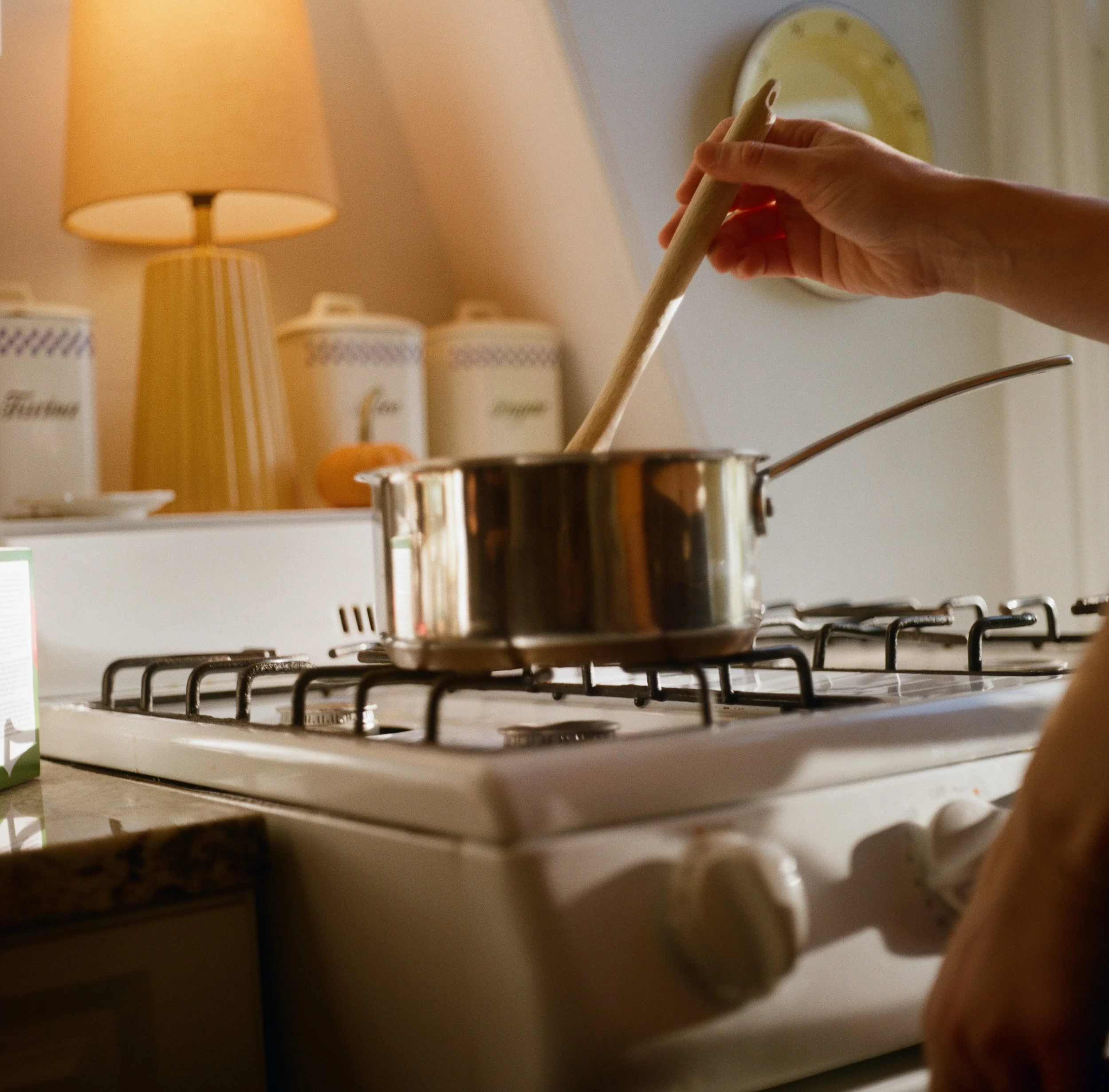 a couple making tea in their boston apartment during their engagement session