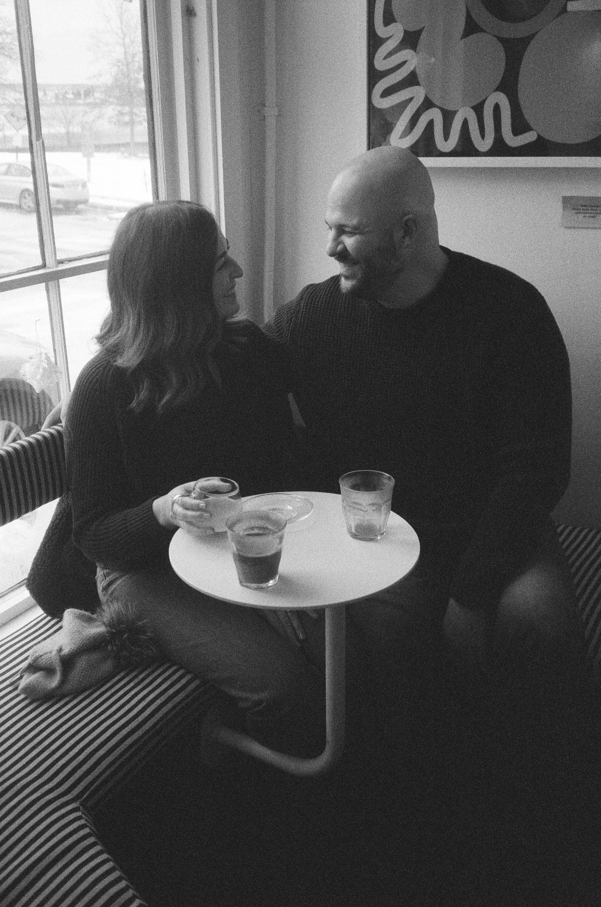 couple sitting at a cafe candidly