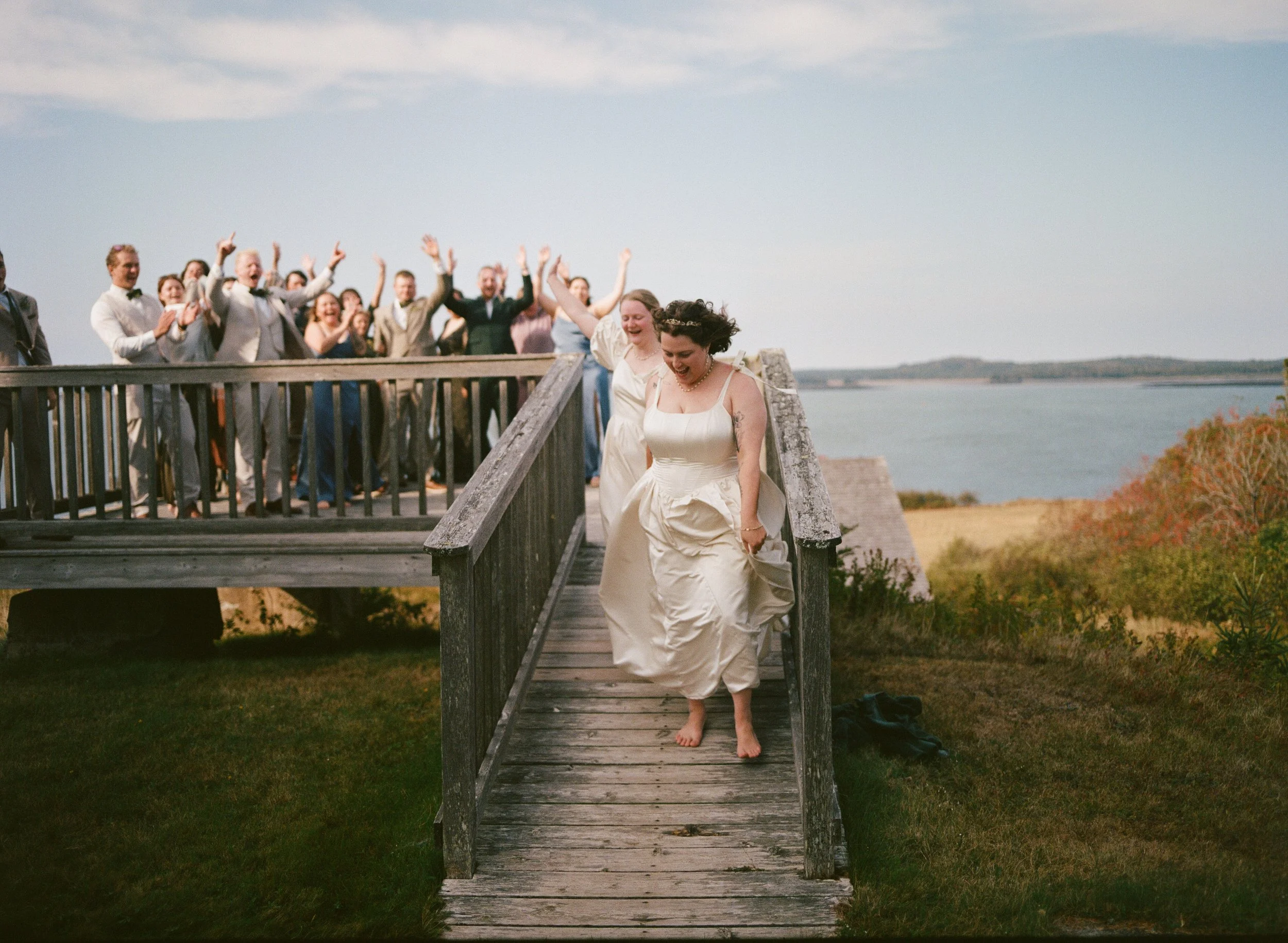 documentary film photography brides exiting outdoor wedding in lubec maine