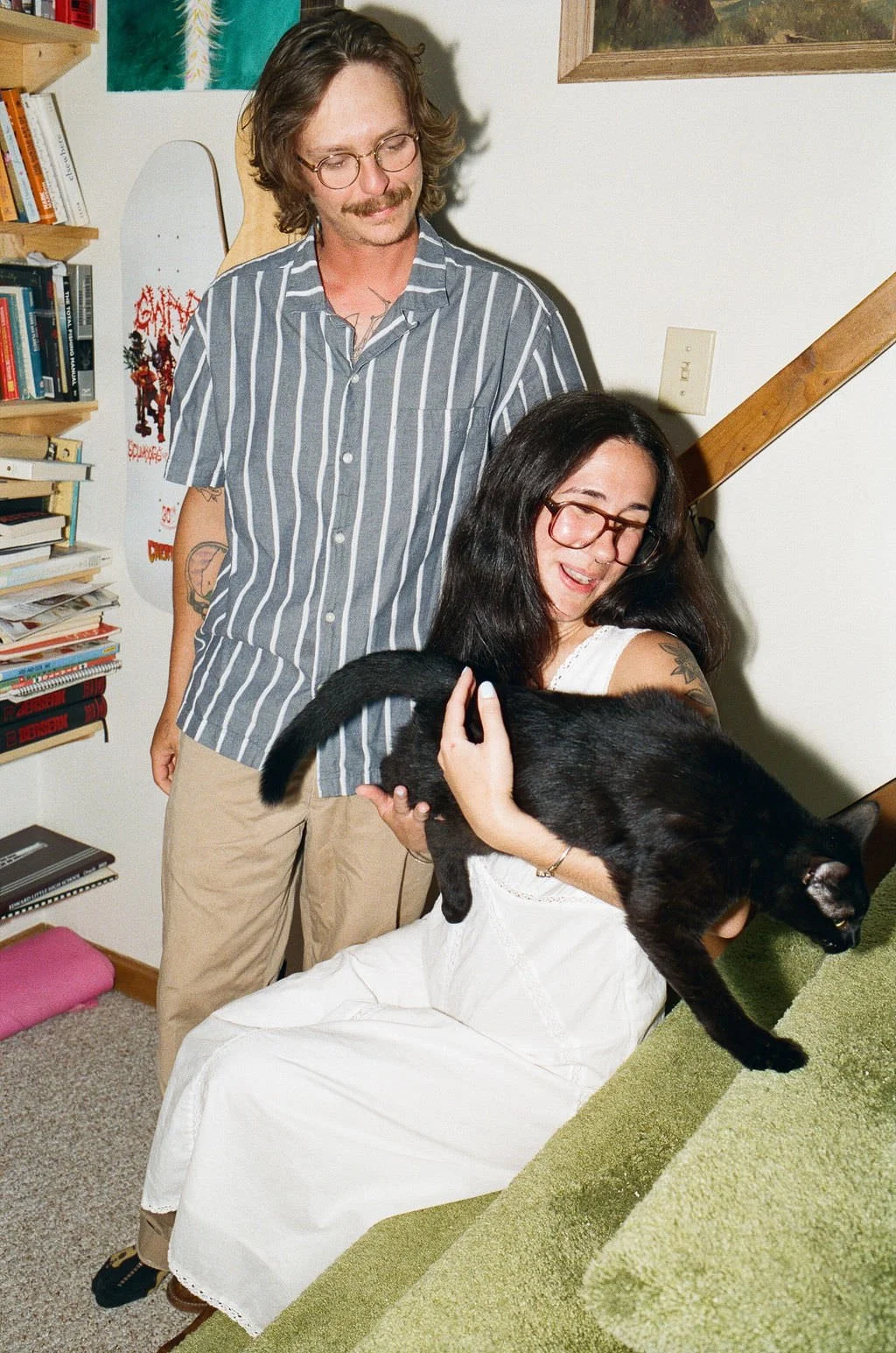 playful engagement photography of a couple with their cat on film in southern maine