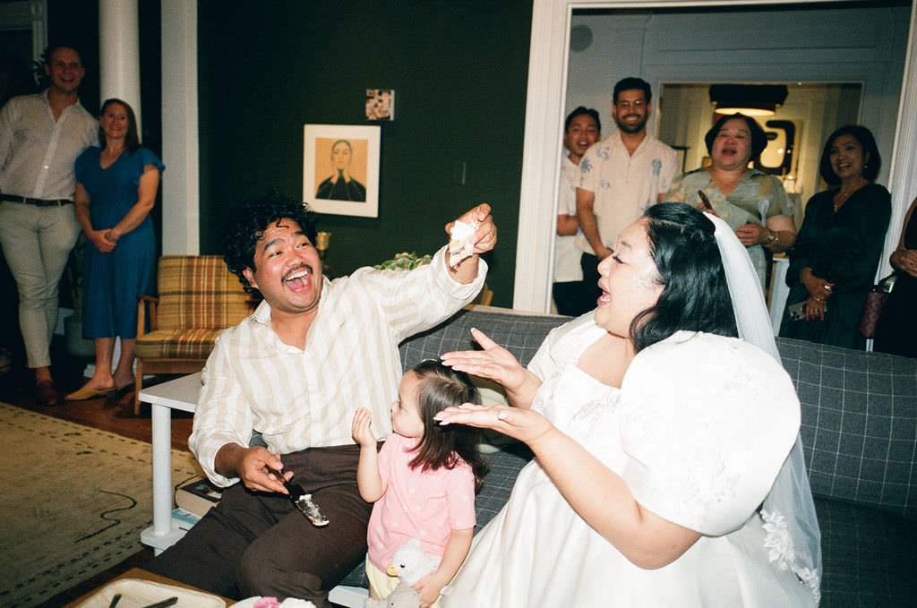 fun filmk photography of cake cutting at intimate wedding in maine