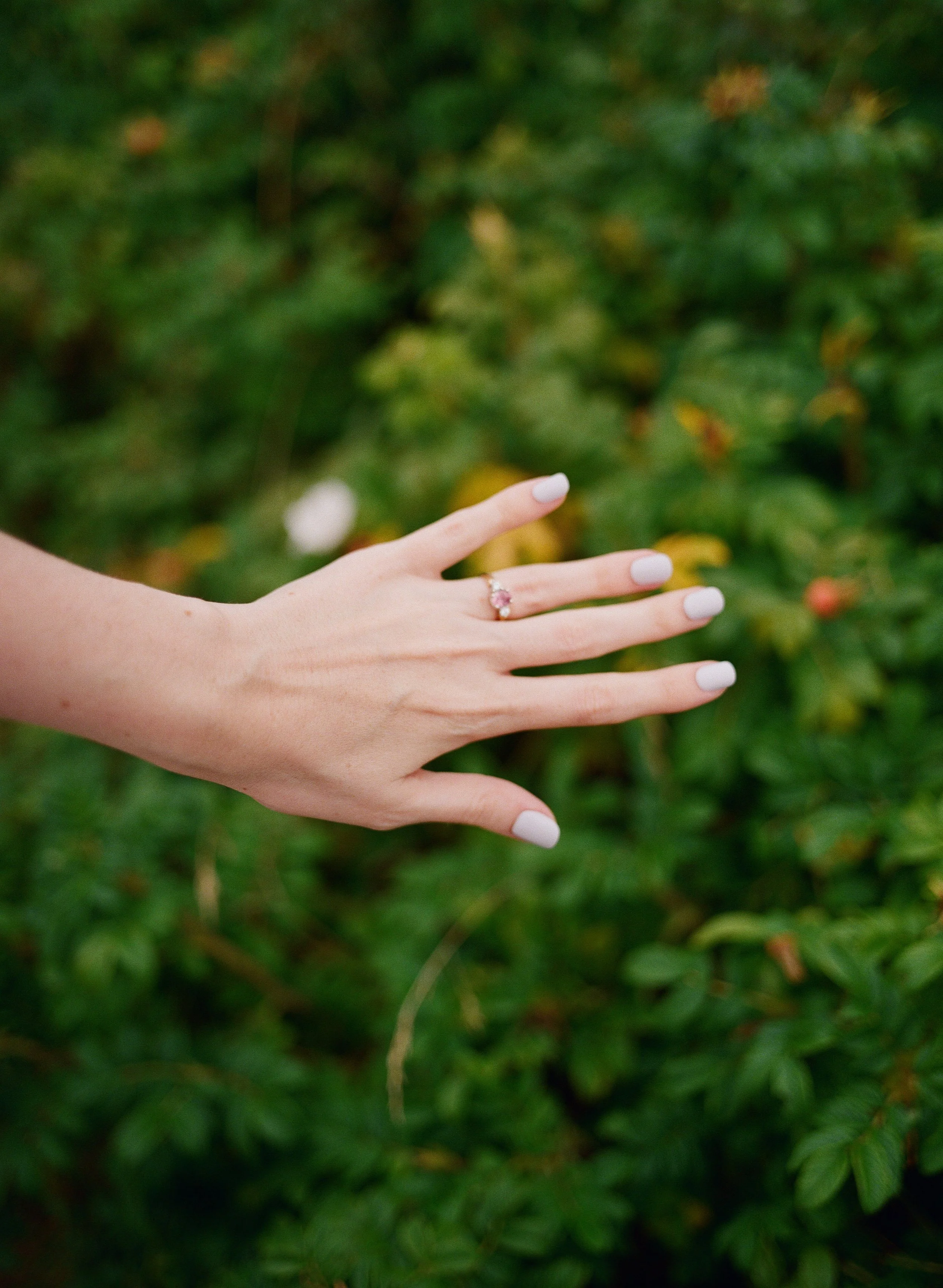 a woman holds out her wedding ring