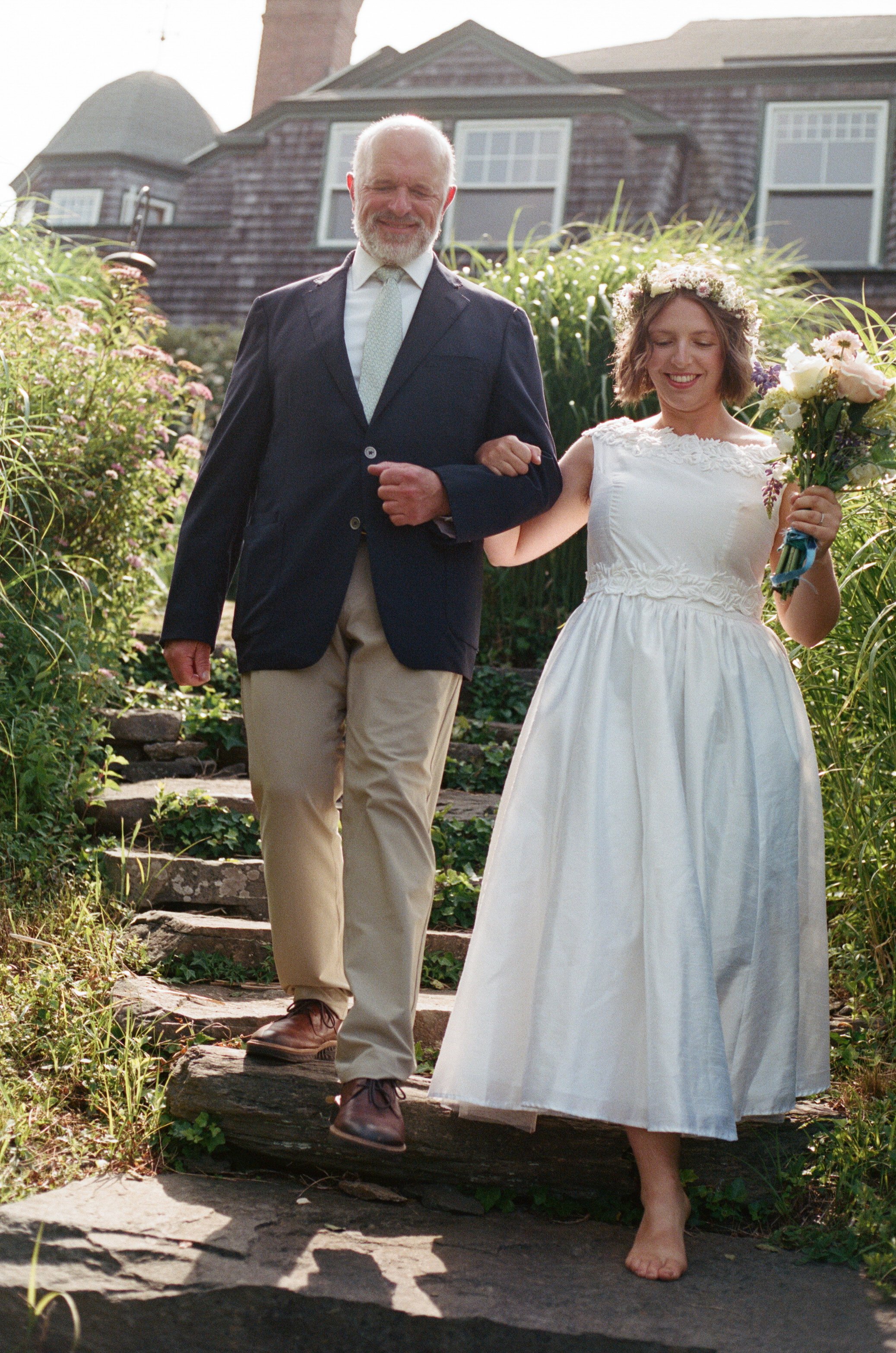 bride and her dad walking down stairs at backyard rhode island wedding