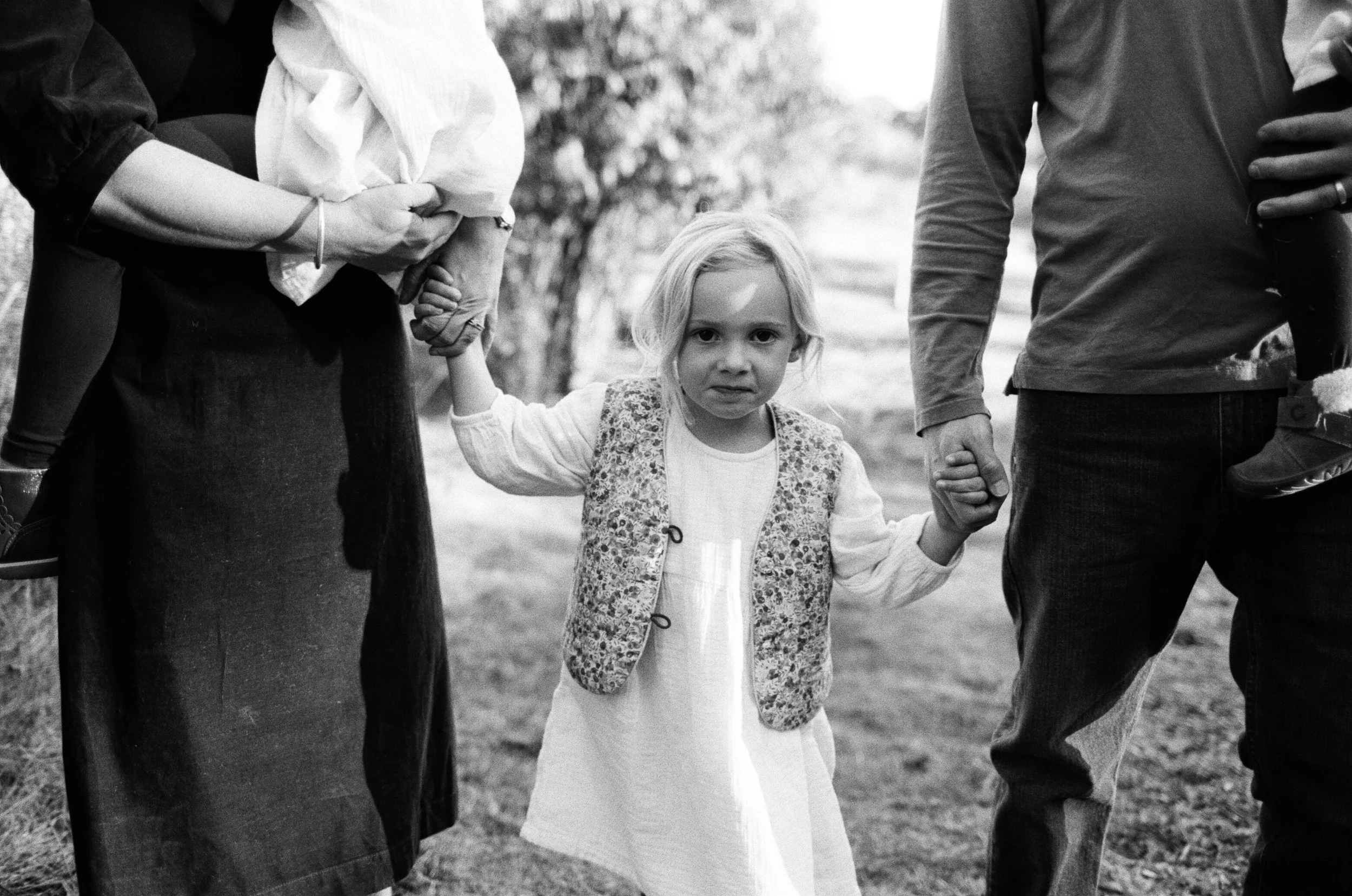 A family holding hands near Hallowell Maine during documentary film photography session