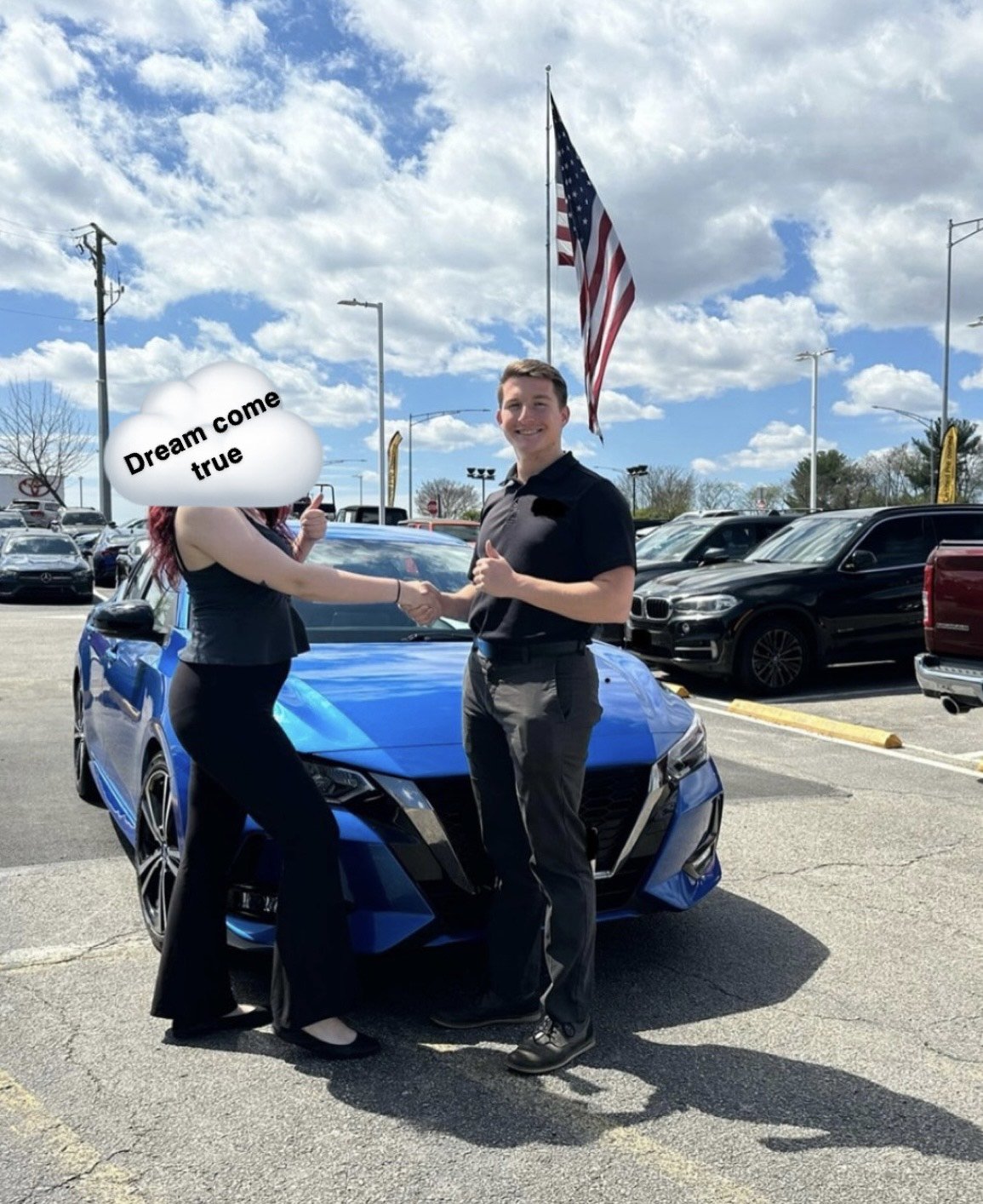 Two people shaking hands in front of a blue car at a dealership, with an American flag in the background; the person on the left has a cloud over their face with the text 'Dream come true.'