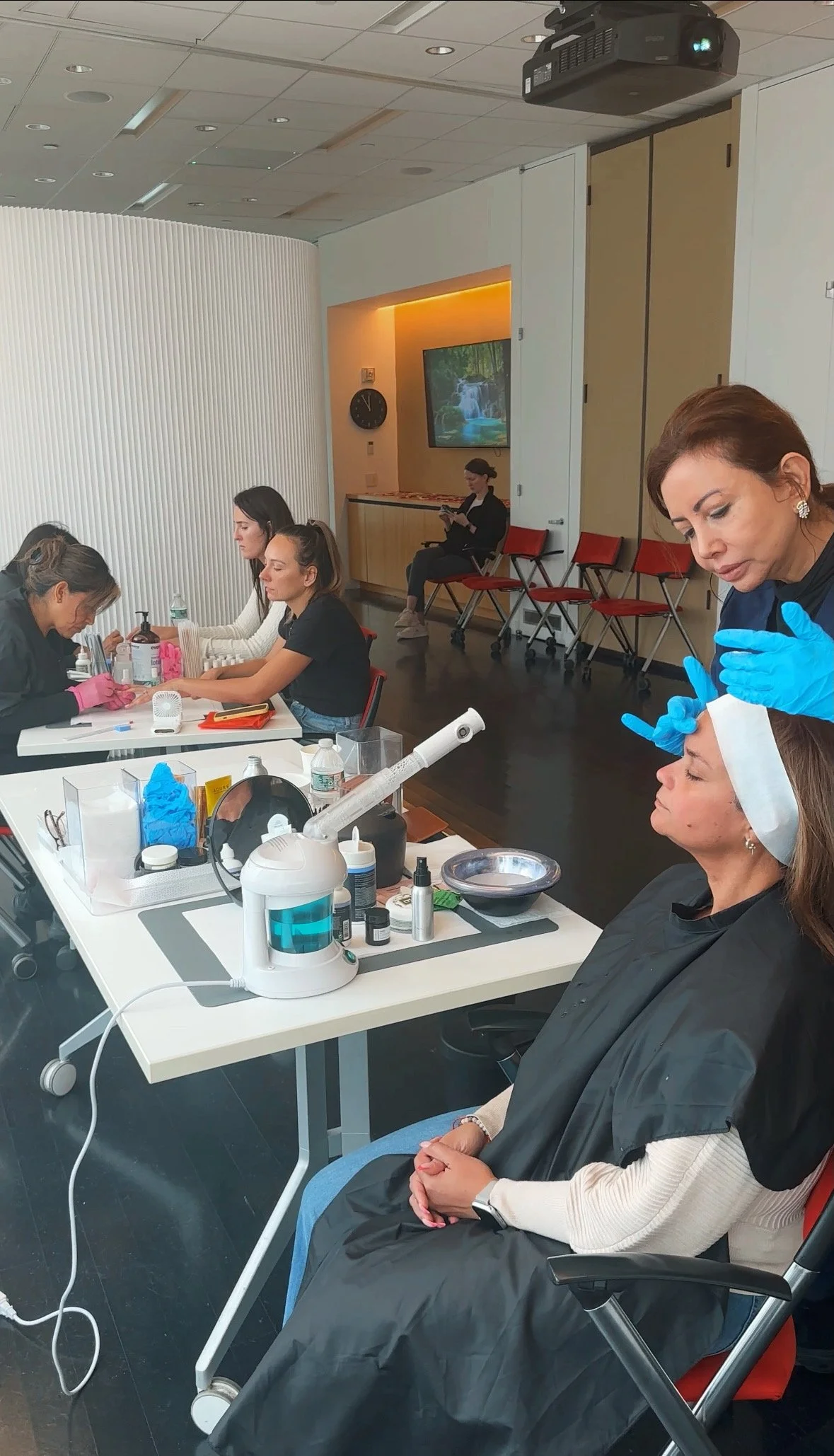 A Primp Events skincare specialist provides a calming facial treatment, as a guest relaxes into a moment of quiet care.