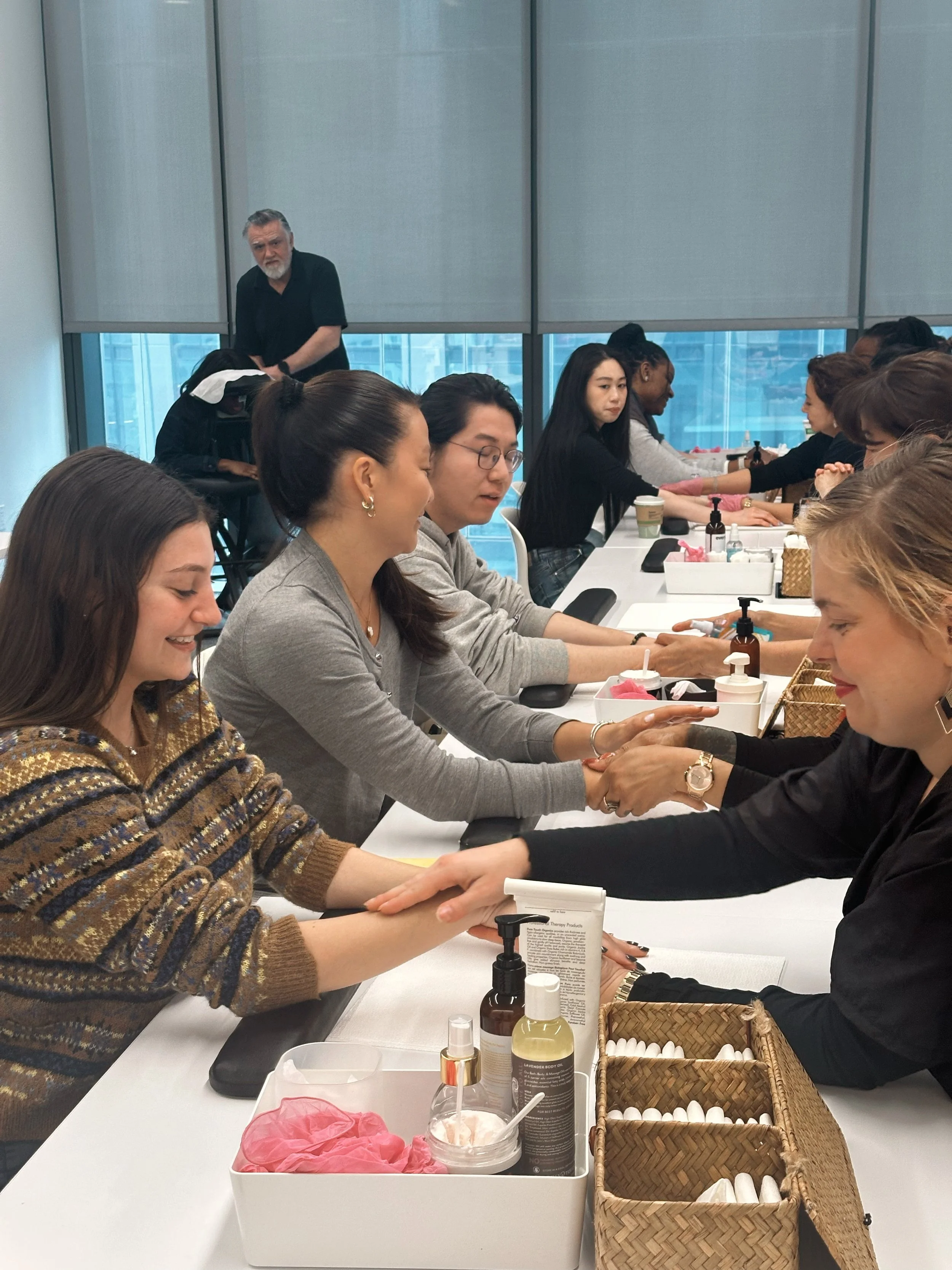 People participating in a handshake event at a workshop or seminar in a modern office conference room.
