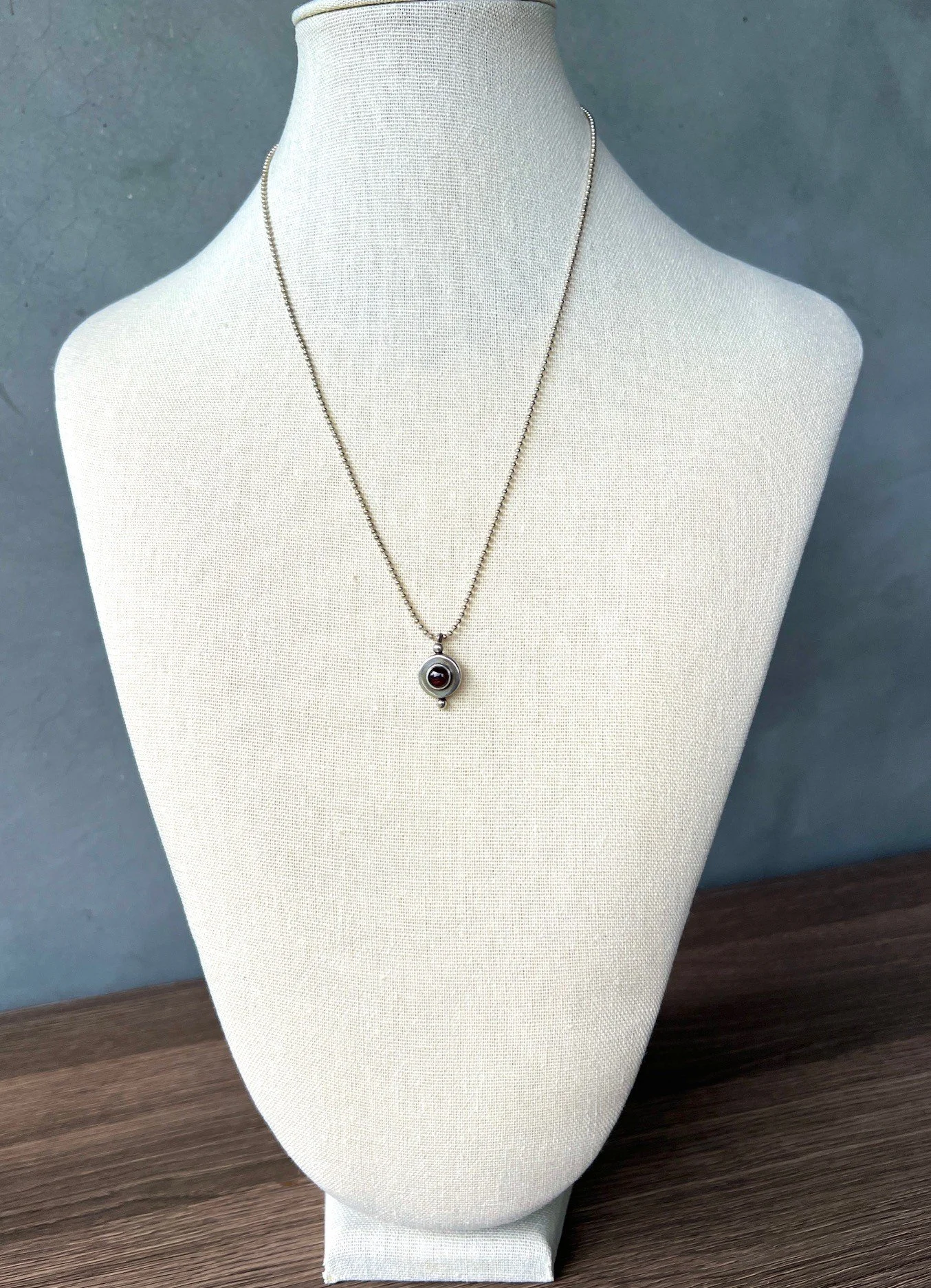 garnet and sterling silver amulet on silver chain