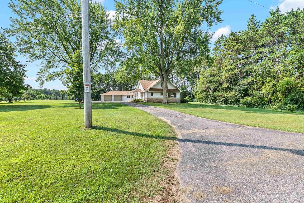 Country house with trees and grassy lawn