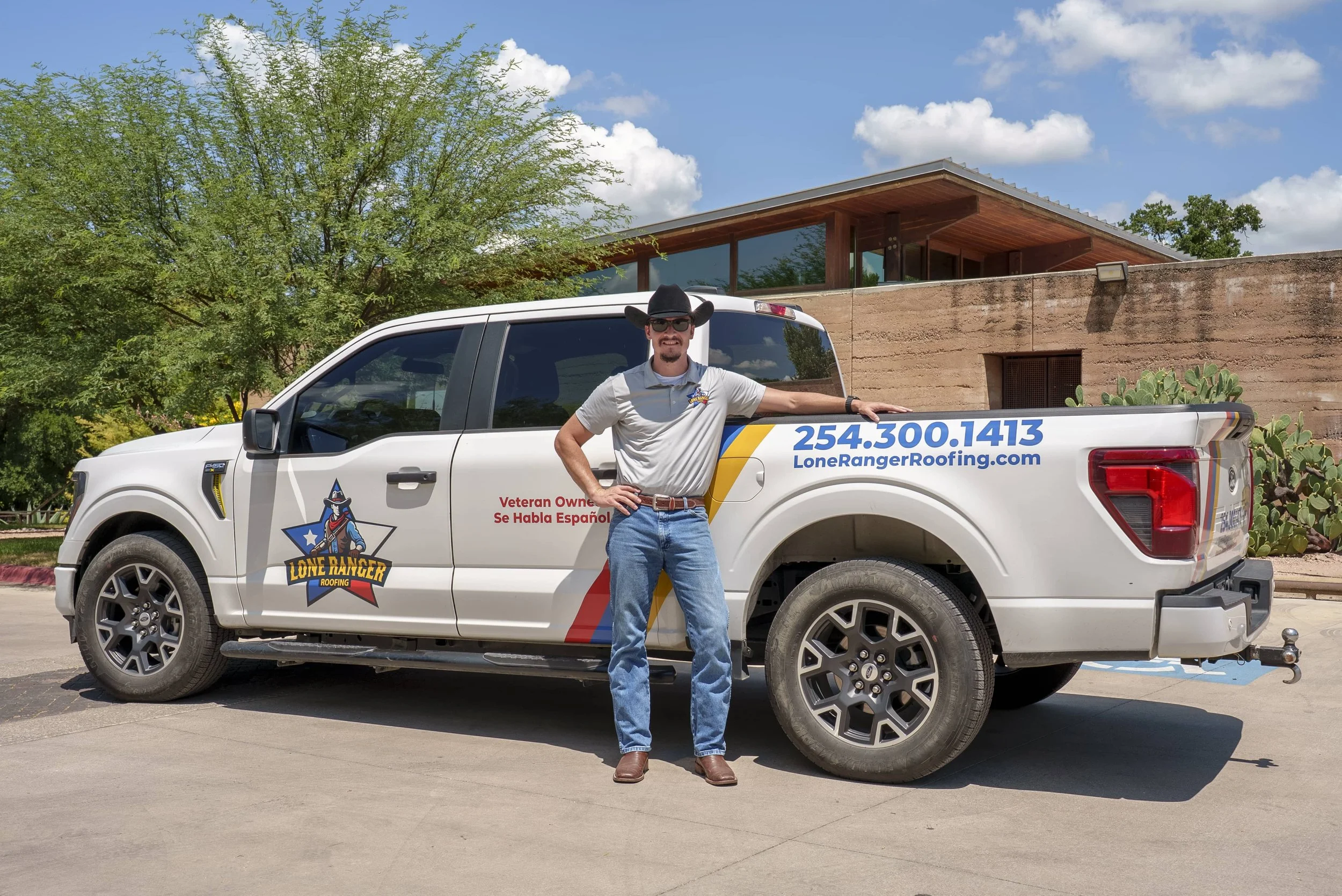Julio Rojas, veteran owner of Lone Ranger Roofing, standing beside a branded company truck in Georgetown, TX.