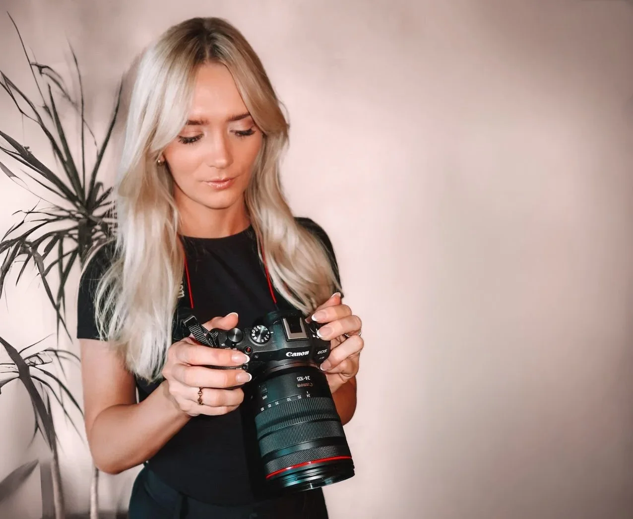 Female CEO looking at camera photos, holding camera
