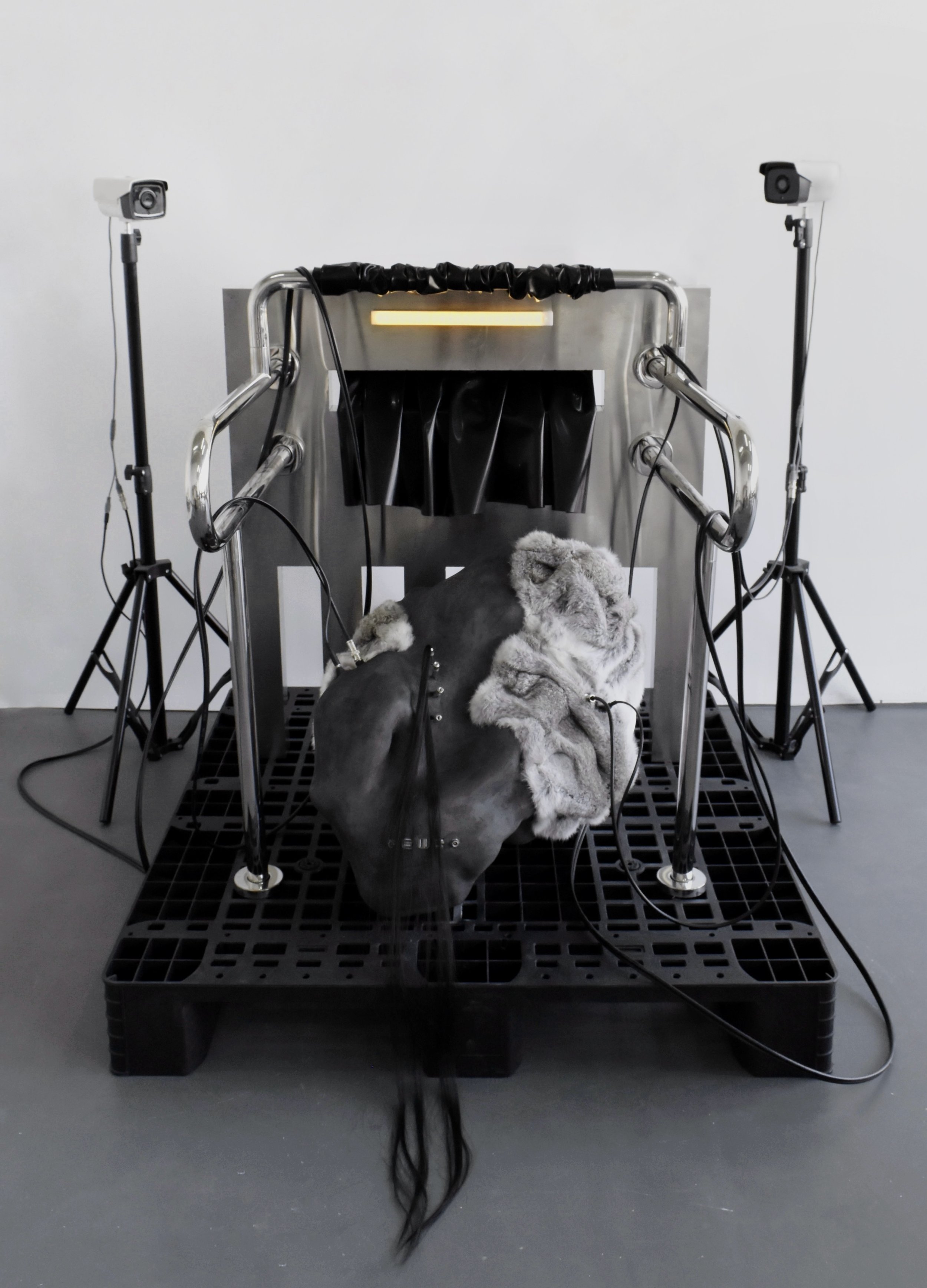 Hear the Voices That Beckon, 2025, Resin, plaster, coal pigment, fur, metal, wires, motion sensor light, security cameras, plastic, synthetic hair, and latex - 170 x 137 x 133 cm