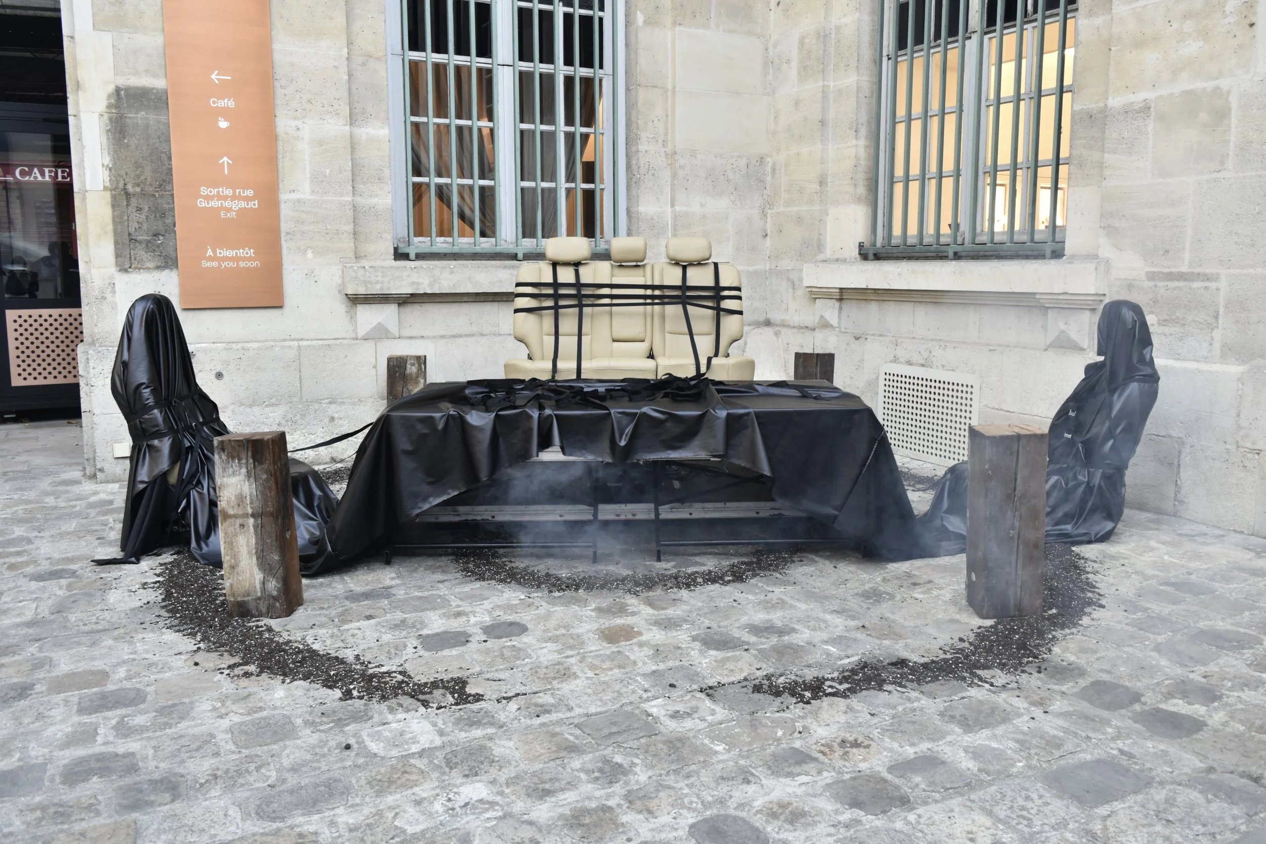 Closed-Circuit Terminal Viewing, 2026, Car seats, stages, faux leather fabric, belt straps, wood, dirt, fog machine, sound and performance - Dimensions variable