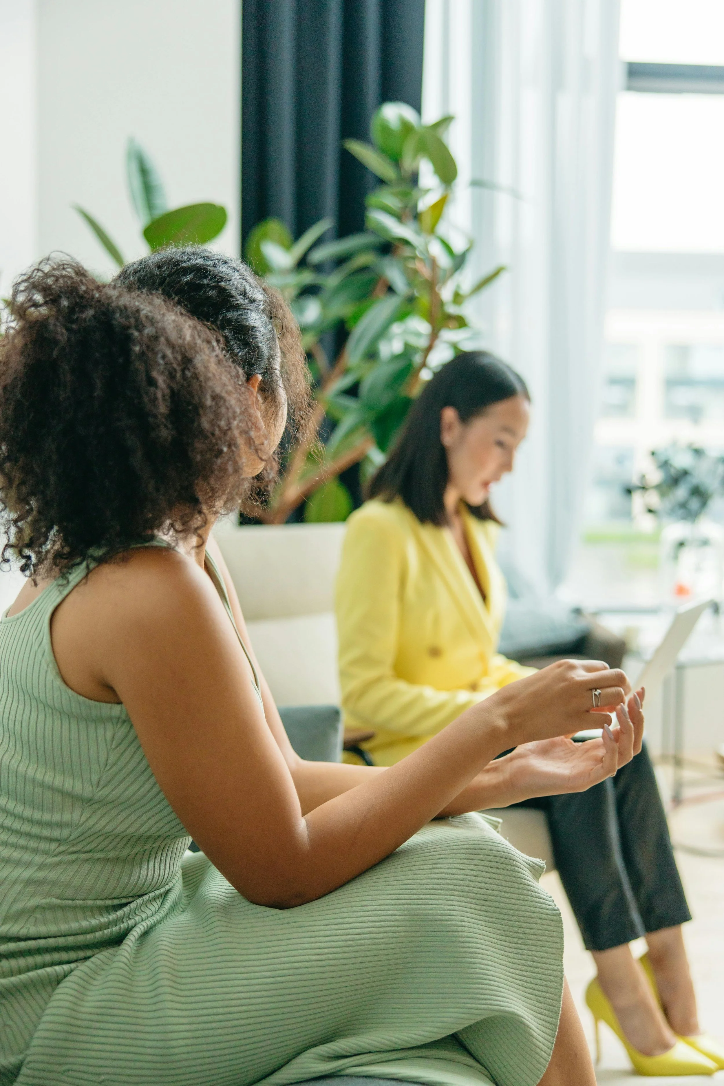Two women in a consultation, one taking notes, during a psychological immigration evaluation in Northern Virginia