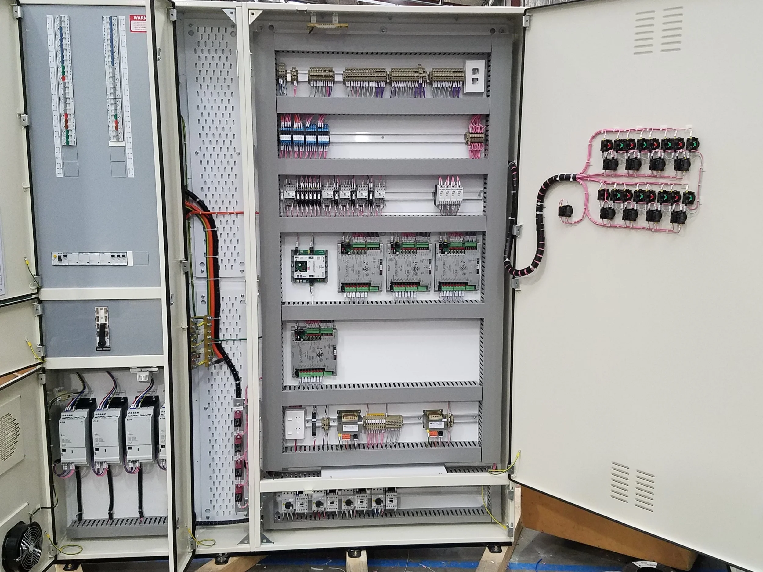 Commercial switchboard with circuit breakers, control equipment and door switches and indicators.
