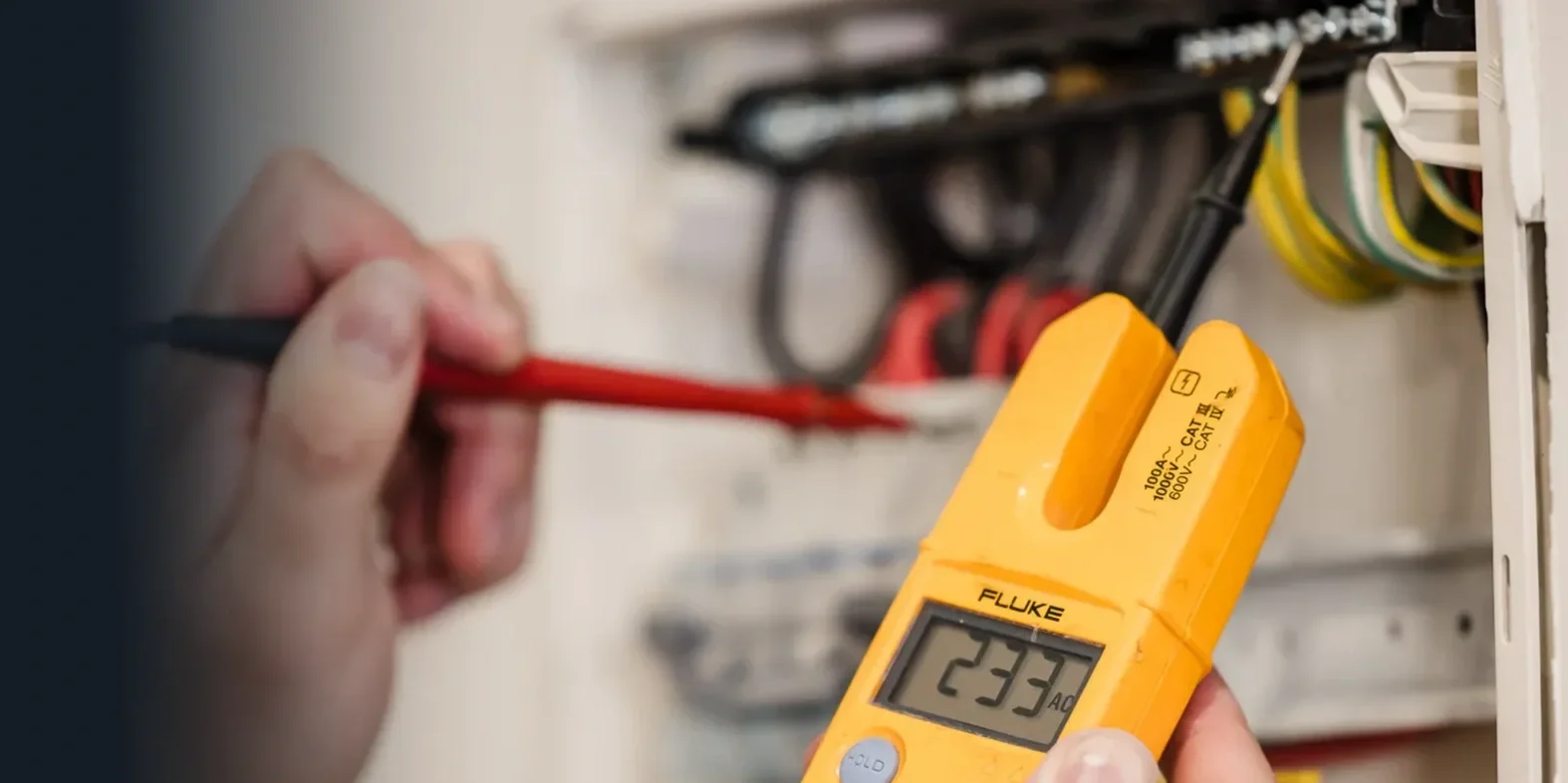 Electrician carrying out electrical fault finding in a residential home.