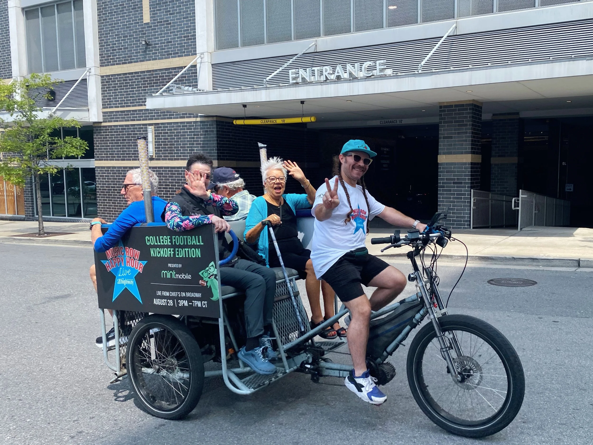 Pro Pedicab driver transporting guests during a branded downtown Nashville event