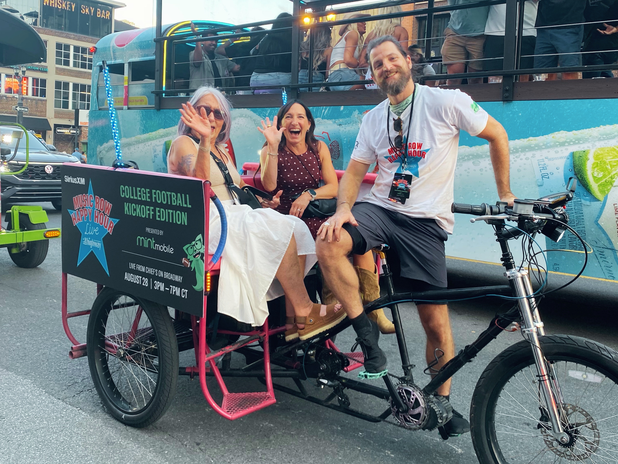Guests enjoying a Pro Pedicab ride during the Music Row Happy Hour activation in downtown Nashville