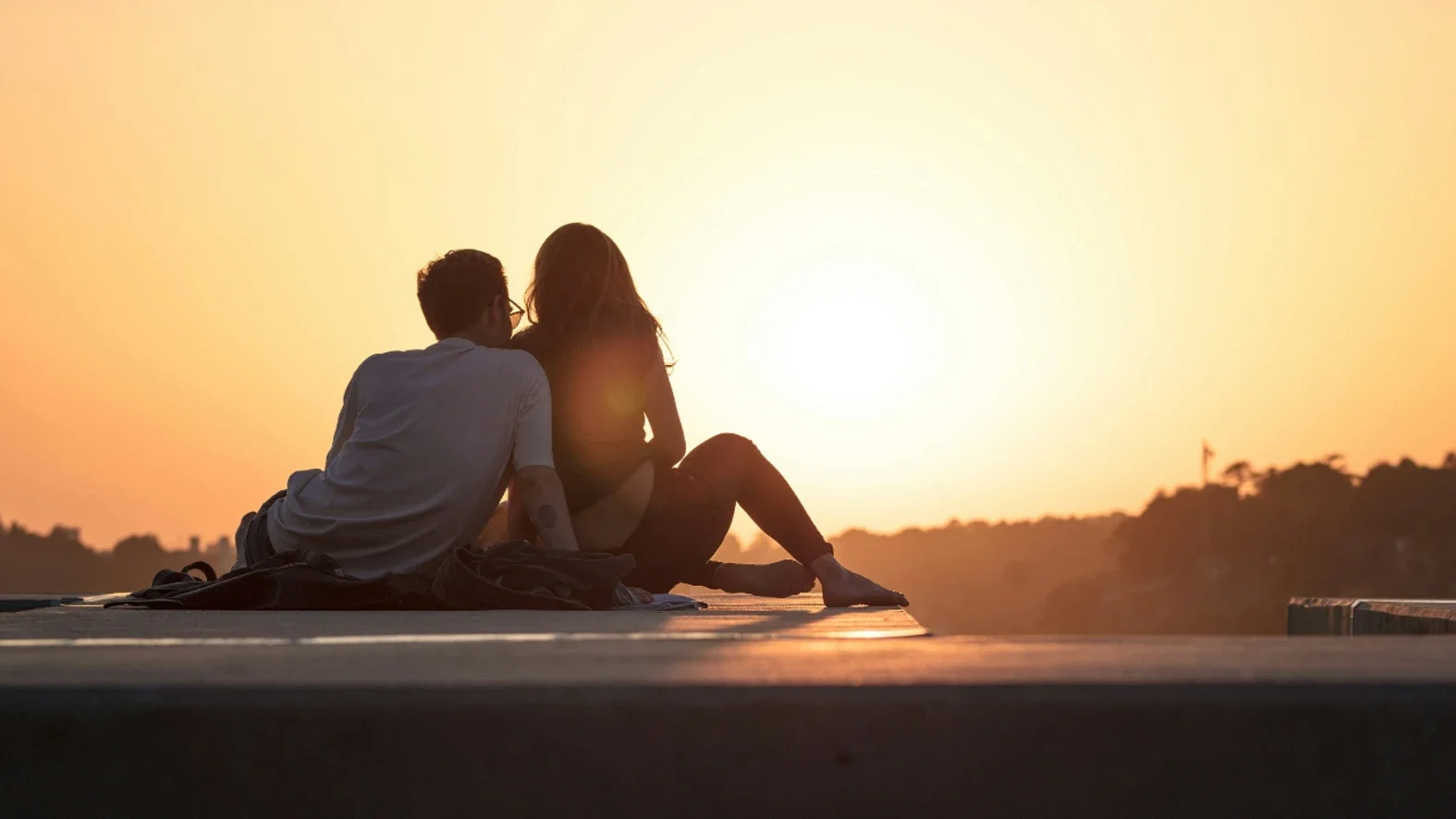 A couple is seen at sunset