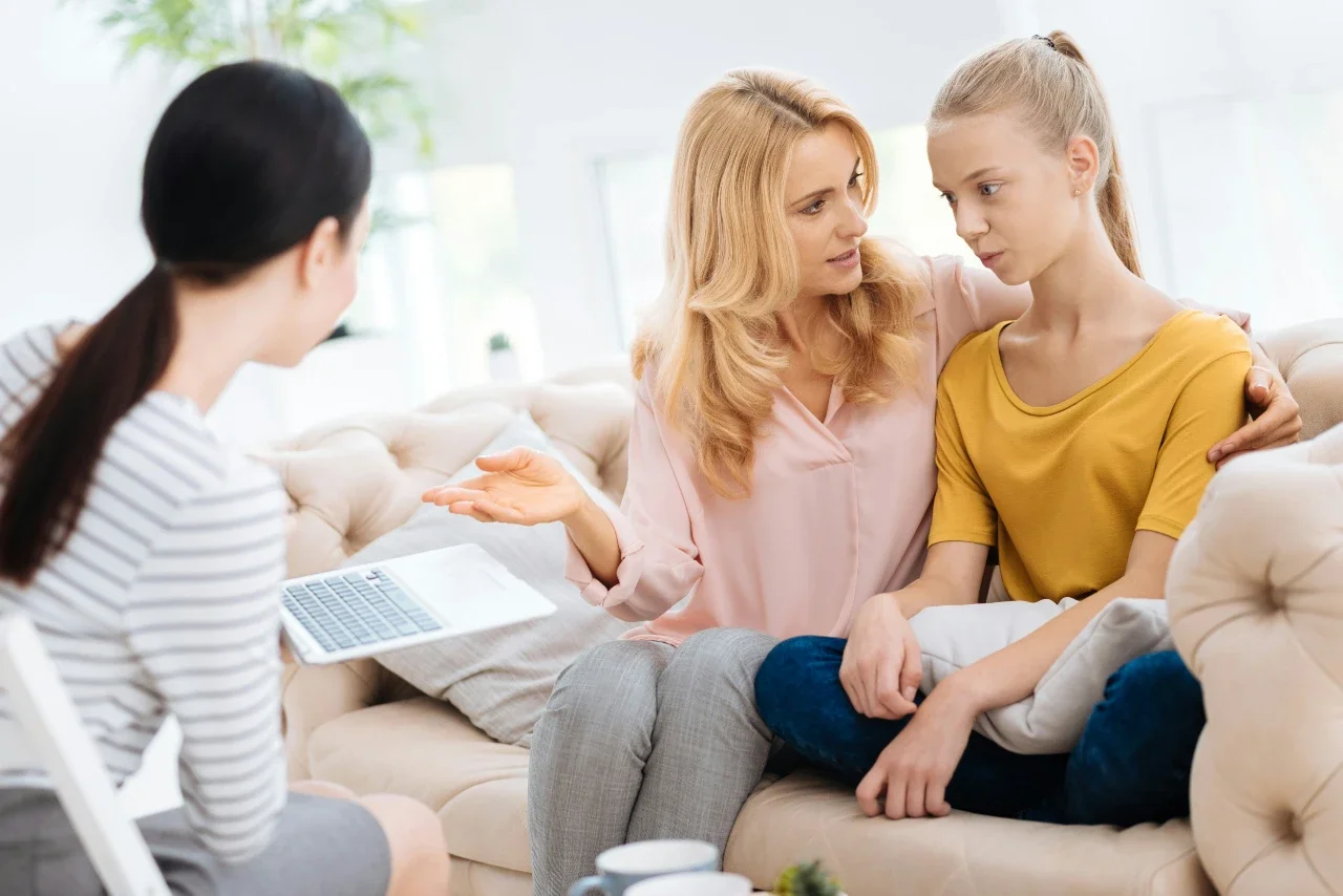 A woman and her daughter attend family therapy