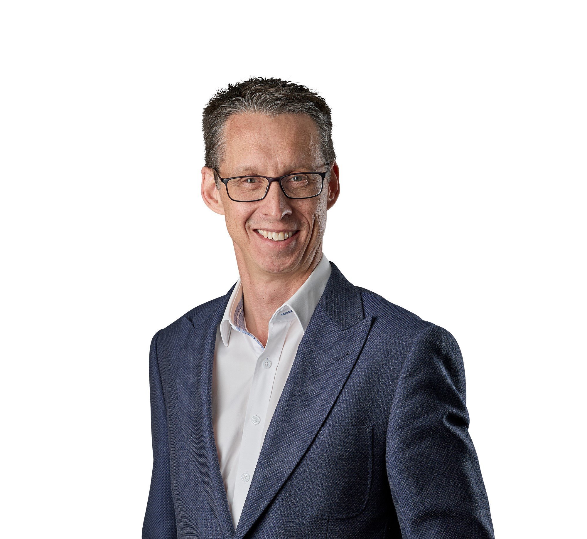 Smiling man with glasses in a navy blue suit and white shirt on white background.