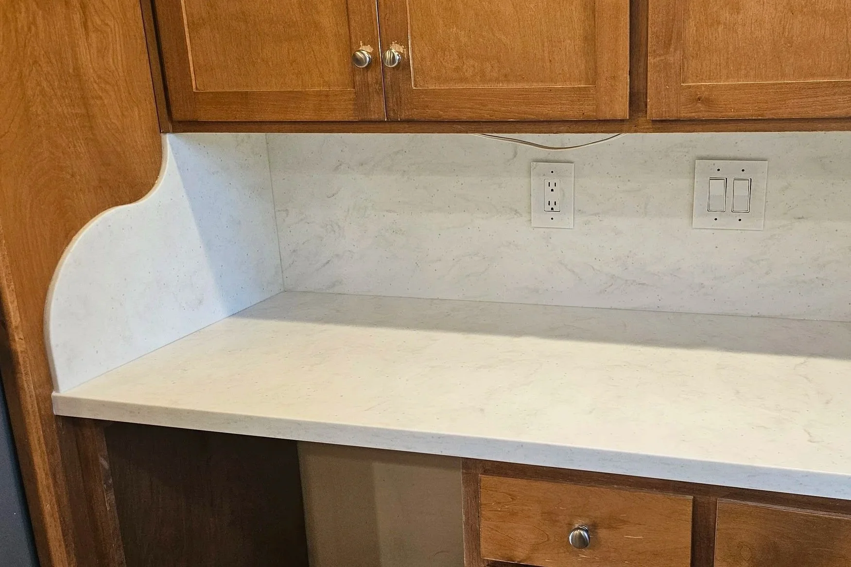 Full-height set-on backsplash flows up to the cabinets; side splash may be customized in some situations